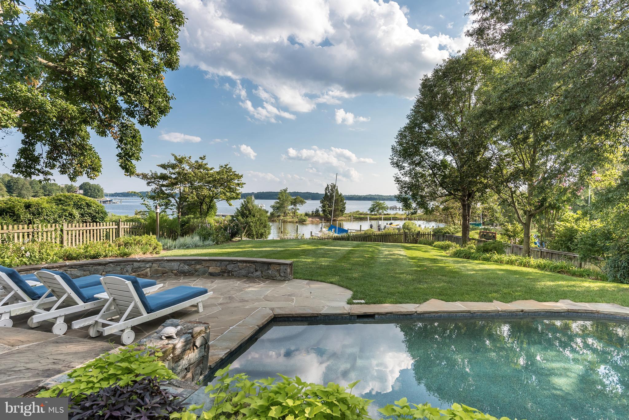 South River Waterfront with expansive water views from this beautifully renovated home. Main Level Master Bedroom w/ private porch overlooking Waterside Pool; Gorgeous Kitchen w/ marble island; Two story Great Room w/a stone fireplace like no other; 4 BR/ 4 BA; Original Heart Pine Floors; Two car Garage. Handicap Accessible. Brand New Private Dock w/ 2 Boat Slips, Boat Lift.