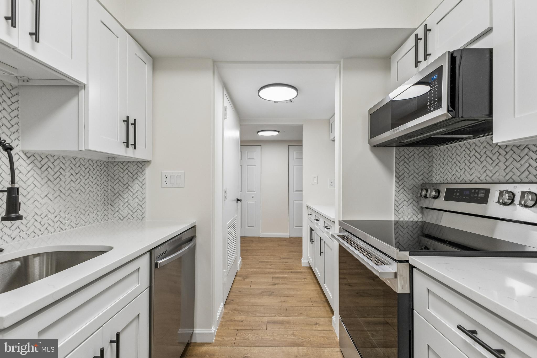 Welcome to this beautifully remodeled 1-bedroom, 1-bath unit with a private balcony and garage parking, located in the highly sought-after Encore of McLean. This residence is part of a gated community offering 24-hour staffed security for added peace of mind and a true sense of safety. This light and bright, freshly painted home has it all- Updated kitchen with new modern white shaker cabinets, granite countertops and new Samsung appliances! NEW HVAC! NEW FLOORS throughout! Updated NEW designed BATH! NEW DOORS! NEW Samsung WASHER AND DRYER in unit! The building features recently updated amenities and a modern lobby, including: Concierge service from 7:00 AM to 11:00 PM, A state-of-the-art fitness center, Secure package room with a digital notification screen, An elegant library, A beautifully furnished social room. A dedicated bike storage room. Enjoy direct access to the skywalk trail, perfect for biking or walking to Tysons Corner Mall and Tysons Galleria. Residents also enjoy seasonal access to the outdoor swimming pool shared with The Regency at McLean within the same complex. The McLean Metro Station is just a short walk away, located at the bottom of the hill at Old Meadow Road and Route 123. Wegmans is only five minutes away. Nearby, ShipGarten offers a vibrant outdoor venue with Tysons Biergarten, McLean Happy Hour, food trucks, and regular beer festivals — a unique multi-concept experience. This home offers an unbeatable combination of comfort, convenience, and location—perfect for enjoying all that McLean and Tysons Corner have to offer. Hurry up and make it your new home!