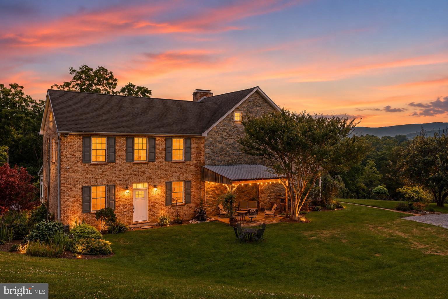 Rarely does a property of this caliber become available in Jefferson County. This extraordinary 20-acre equestrian estate seamlessly blends the timeless charm of an early 1800s Three-bedroom, easily four, 2.5-bath stone home with thoughtfully designed horse facilities, exceptional outdoor living spaces, breathtaking mountain views, and the investment potential of two independently buildable 10-acre parcels.

Tucked away at the end of a quiet dead-end road, the property offers remarkable privacy while remaining just minutes from historic Harpers Ferry and within easy commuting distance of Northern Virginia. A picturesque tree-lined drive welcomes you home, bursting with spectacular fall color each autumn, while mature woodlands, neighboring farmland, and a scenic portion of Elk Run create a peaceful setting rarely found today.

The beautifully maintained historic residence showcases original wide-plank hardwood floors, exposed stone walls, and two wood-burning fireplaces, preserving nearly two centuries of craftsmanship. A thoughtfully designed addition blends seamlessly with the original home, while the light-filled sunroom captures panoramic views of the surrounding countryside.

Designed with both horse and rider in mind, the equestrian facilities are truly turnkey. The six-stall center-aisle barn features attached individual sacrifice paddocks for each stall, abundant lighting, ceiling outlets for safely installing stall fans, a wash stall with hot and cold water, a tack room, and a full loft offering exceptional storage or future finishing potential (subject to approvals). Two additional storage sheds accommodate hay and bulk bedding, while a substantial 26' x 50' garage provides ample room for tractors, trailers, equipment, and farm implements.

The professionally engineered expansive riding arena features a geotextile fabric base, layered gravel foundation, bluestone, and premium silica sand footing, with additional crumb rubber will convey. Six interconnected four-board oak-fenced paddocks provide exceptional flexibility for turnout and pasture management, connected by strategically placed gates and separated by an ample alley that allows direct access to the arena without traveling through occupied pastures.  Frost-free automatic waterers, and a large run-in shed complete the exceptional equestrian amenities.

Beyond the arena, enjoy open areas and wooded portions of the property that offer opportunities to establish or restore trails for horseback riding, hiking, nature walks, or ATV adventures. Beautifully designed outdoor entertaining spaces surround both the home and barn, featuring multiple gathering areas, patios, and an impressive custom stone fire pit with generous seating for family and friends.

Whether you're seeking a private country estate, premier horse farm, boutique boarding or training facility, or a unique investment opportunity, this exceptional property offers a rare combination of historic character, modern equestrian infrastructure, outstanding privacy, and long-term potential. Properties that successfully combine authentic 19th-century architecture, professionally developed equestrian facilities, and future development opportunities are extraordinarily rare. This is one of them.