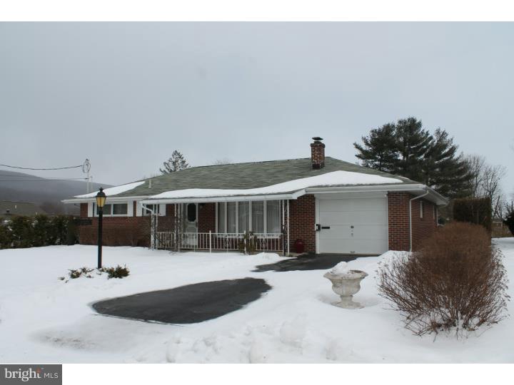 One floor living on a quiet street with spectacular views of the mountains. Brick rancher offers beautiful hardwood flooring, living room with large picture window and wood burning fireplace (gas insert) flanked by built-ins, eat-in kitchen has two ovens and overlooks sun room, three bedrooms, 1 full bath, 2 half baths, storage/gardening room, spacious yard and storage shed.