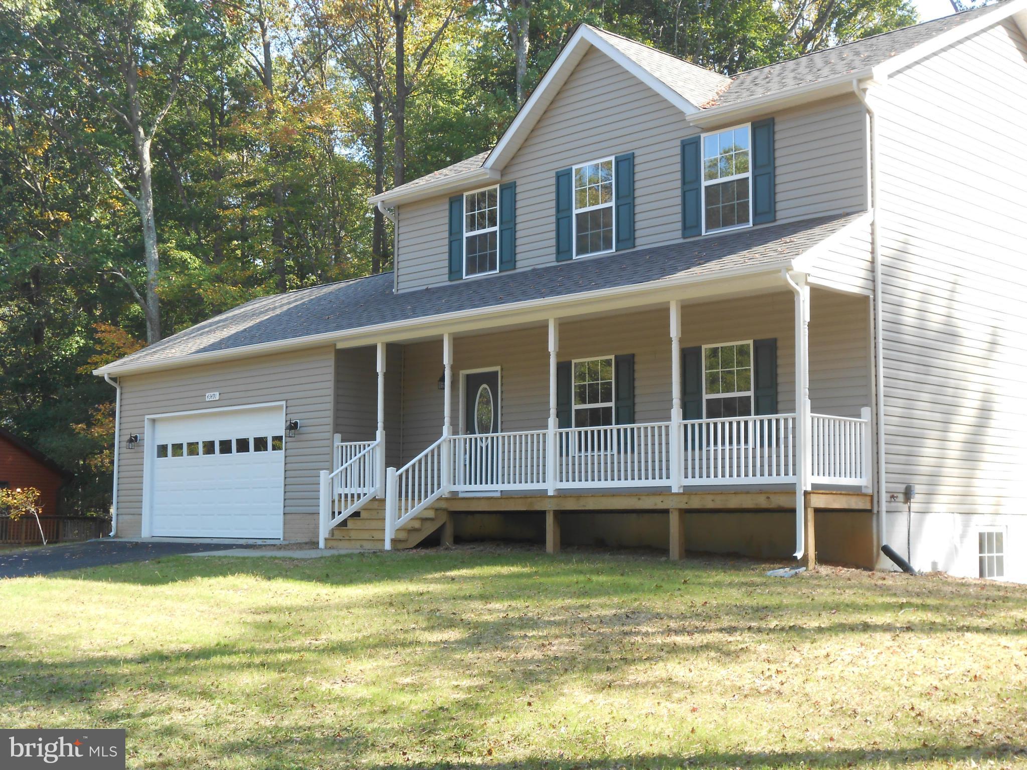 Brand new and ready to be moved into. 2700 sq. feet of finished space. Separate living room, family room,exercise room and or office.  Lots of space.  Full finished walkout basement.  2 car garage with paved driveway.Stainless steel appliances, walk in closets and title floor in kitchen, dining room and baths. All on 2.82 acres.  Nice.