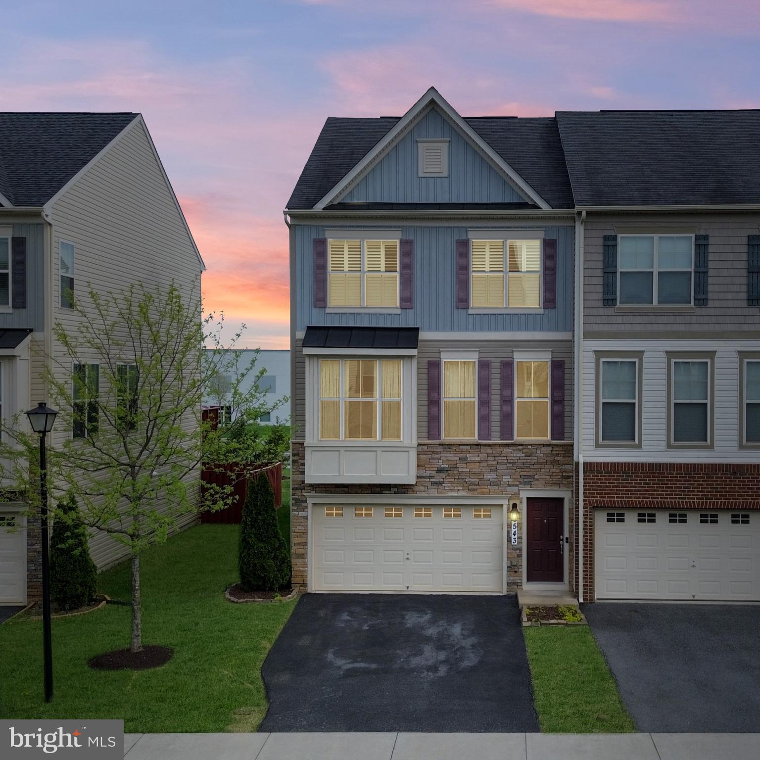 This gorgeous 3-level end-unit townhome offers a contemporary layout with spacious, light-filled rooms and numerous upgrades throughout. Featuring 4 bedrooms and 3.5 full bathrooms, this home has plenty of space. The convenient lower-level bedroom blends form and function effortlessly with its connected full bathroom. Use this room as a bedroom, office or workout room! The lower walk-out level also features a great living area that is perfect for watching TV or playing games and has convenient access through the two-car garage. Enjoy privacy in the flat fenced-in backyard featuring a concrete patio. On the main level, you will find an open-concept space that is great for entertaining with gleaming hardwoods and tall ceilings. The gourmet kitchen is complete with granite counters, Stainless Steel appliances, plenty of cabinetry, a large island with a breakfast bar and a spacious eat-in dining area. The kitchen flows seamlessly into the light-filled family room. Walk out from the kitchen onto the deck, which provides a great space for relaxing with that morning cup of coffee! The Primary Suite is expansive with a spacious walk-in closet and a connected spa-like Primary Bath with dual sinks and a tile shower with a built-in bench. This level features two more spacious bedrooms, a full hall bathroom with a dual vanity, and a conveniently located laundry room. Two of the bedrooms are upgraded with plantation shutters. Situated just a short distance from various shops and restaurants, grocery stores, and the charming downtown area of Frederick. With easy access to major commuter routes, this home is a must-see. Don't miss the opportunity to make this stunning house your home!