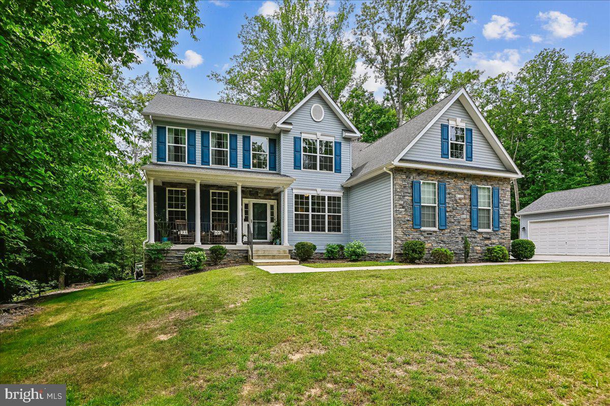 Welcome home to a rare find in this secluded retreat in the heart of Arnold Maryland. At the end of a long private driveway, surrounded by many acres of forest conservation woodland, this four bedroom, three and a half bath home is a perfect sanctuary. Set up for one level living with a primary bedroom and attached bath and laundry on the main level. With a wonderful gourmet kitchen and all stainless appliances, including a cooktop and true double oven. Vaulted ceilings in the large great room with a wonderful wood burning fireplace. From the dining room step out to a wonderful deck with plenty of room to enjoy the peaceful atmosphere. Three large upstairs bedrooms, share a full bath, and the basement is a clean slate for a buyer to make their own, but with a big finished rec room and beautiful full bath. A two car attached garage and a two car detached garage provides plenty of parking for all types of vehicles. The original 39 acres are surrounded by trails for hiking or off road vehicle fun. This tucked away retreat is only minutes from shops and restaurants and minutes from commuter routes to Annapolis, Baltimore, DC, and Ft Meade. Broadneck school district.