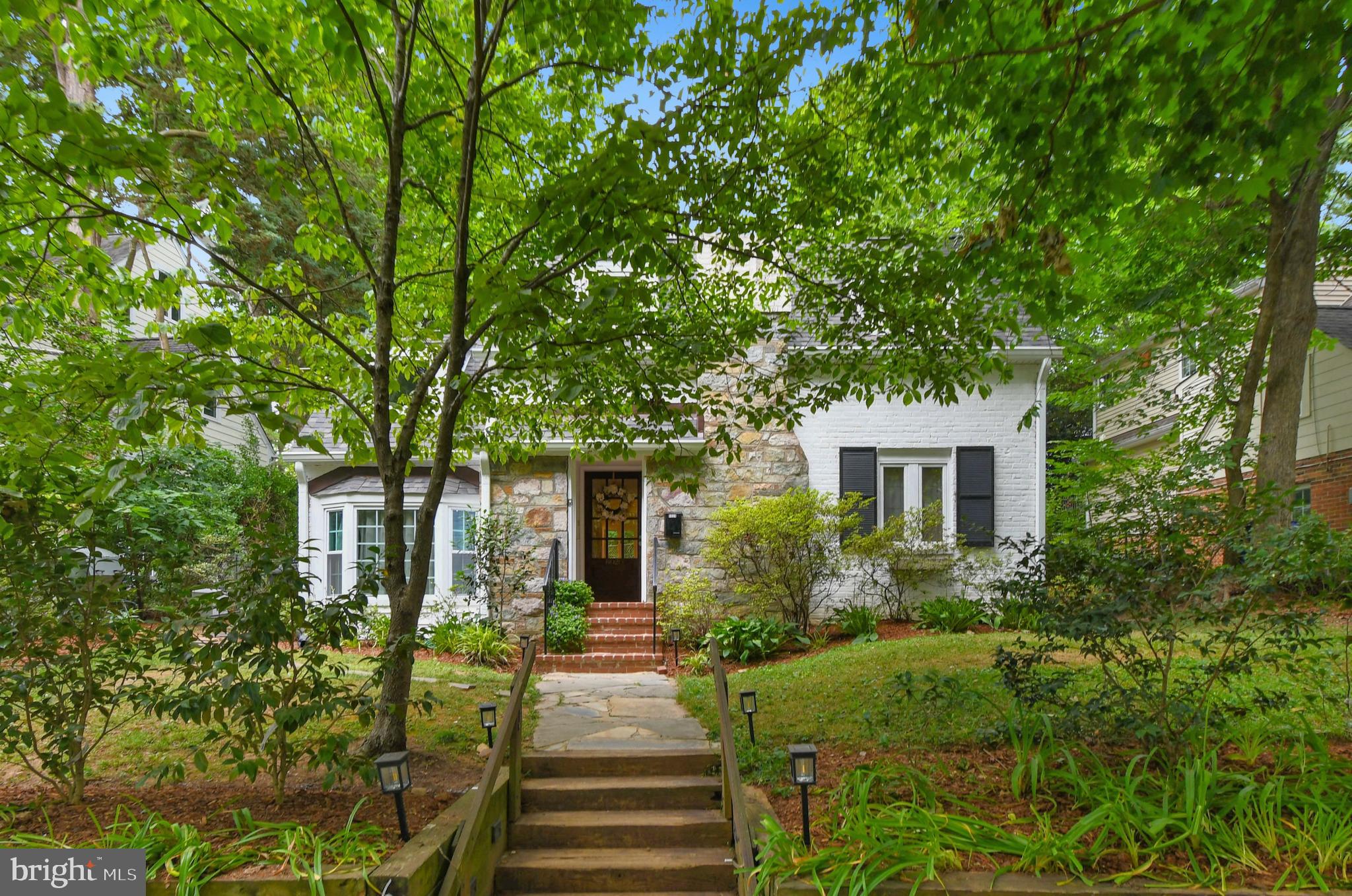 Photos late Friday!! Storybook charm meets one of the DC area's best-kept secrets. Open Sat 6/20 1-3 and Sun 6/21 1:30-3:30
Welcome to Brookmont, a treasured neighborhood that feels like a small town hidden in plain sight. With no through traffic, a beloved Village Green, weekly farmers market, playground, tennis courts, and a genuine sense of community, it's easy to see why residents rarely leave. Less than a  mile from the DC line, Brookmont offers the kind of neighborly charm most people think no longer exists—more like Louise Penny's fictional Three Pines than suburb. Perched above the Potomac with scenic overlooks, kayaking, biking and the C&O canal and towpath are easily accessible.
This delightful two plus bedroom, two-bath cottage is every bit as inviting as its surroundings. Sun-filled living spaces include a welcoming living room, a flexible dining/family room, an efficient and well-designed kitchen, and a lower-level recreation room that expands the home's livability.
The main level boasts a charming white table space kitchen, spacious living room with stone fireplace, addition with dining area and family room and a study/reading area. Upstairs there are two bedrooms, one with an adjacent office/nursery and a full bath. The lower level has a recreation room, full bath and systems/laundry area. Step outside and discover your own private sanctuary. The enchanting outdoor spaces are perfect for morning coffee, evening gatherings, or simply unwinding amid the peaceful surroundings.
Even better, the big-ticket updates have already been done. Recent improvements include a new roof and gutters, replacement of the exterior siding, a 2023 HVAC system with surge protection, chimney repointing and recapping, new carpeting, and an app-controlled EV charger.
A home with character. A neighborhood with soul. A rare opportunity to enjoy both.