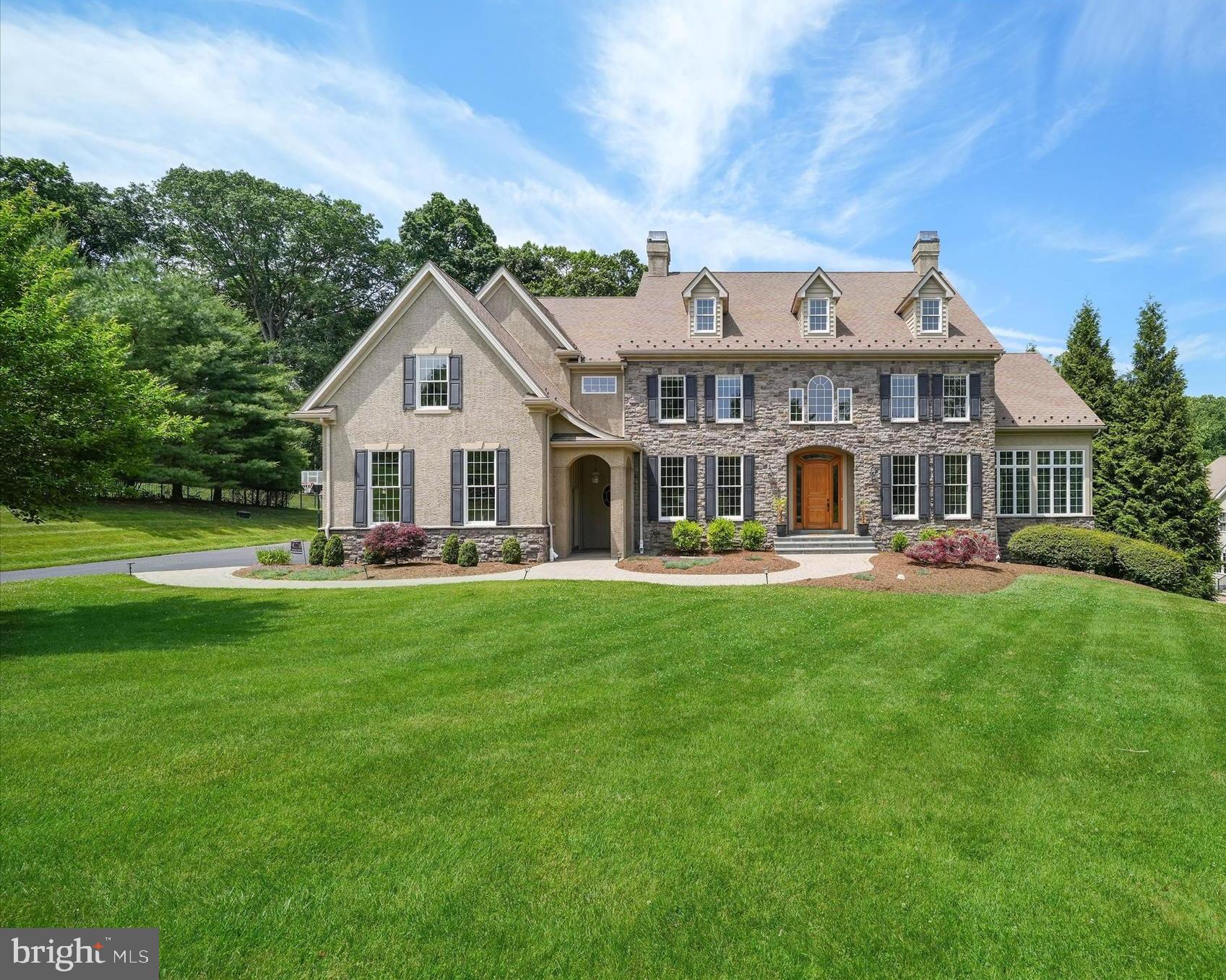 Welcome to 210 Fulling Drive, an exceptional luxury estate situated on 2.4 beautifully landscaped acres in the prestigious Carlton North Gate community of Chadds Ford. Comprised of just 15 custom-built luxury homes, each situated on approximately 1 to 5 acres, Carlton North Gate provides the perfect balance of privacy, space, and community living. Offering approximately 7,890 square feet of finished living space, this custom residence seamlessly blends timeless elegance, superior craftsmanship, and resort-style amenities.

An impressive oversized solid oak front door, complemented by the home's elegant stone exterior, welcomes you into a stunning interior featuring high ceilings, extensive millwork, abundant natural light, and Brazilian Cherry hardwood floors throughout the main level. Designed for both everyday living and elegant entertaining, the home features an expansive conservatory filled with natural light and a dramatic great room anchored by a stunning stone fireplace. The gourmet chef's kitchen is appointed with premium Viking and Sub-Zero appliances, a walk-in pantry, and a spacious breakfast area highlighted by a dramatic wall of windows that fills the space with beautiful morning sunlight. Completing the main level is a private first-floor office, ideal for today's work-from-home lifestyle.

Each bedroom features its own ensuite bath, providing exceptional comfort and privacy. The luxurious primary suite serves as a private retreat, complete with a sitting room featuring a gas fireplace, spacious accommodations, and a spa-inspired ensuite bath designed for relaxation and rejuvenation.

A secondary family staircase adds both convenience and functionality to the thoughtfully designed floor plan. The finished lower level is designed for entertaining and everyday enjoyment, featuring expansive recreation space, a fitness area overlooking the pool and backyard, a versatile bonus room, full bath, and abundant storage.

Step outside to your private backyard oasis highlighted by a custom Clark's Pool featuring a dramatic waterfall that adds both beauty and serenity to the outdoor living experience. Extensive Laurel Gardens landscaping and hardscaping create a resort-like setting ideal for entertaining or quiet relaxation. Professional outdoor lighting enhances the property's beauty and ambiance, while additional features include a landscape irrigation system, invisible pet fence, and decorative window candle package. An oversized three-car garage with substantial storage space completes this extraordinary offering.

A rare opportunity to own one of Chadds Ford's premier luxury homes in an exceptional setting, offering privacy, sophistication, and an unparalleled lifestyle.
