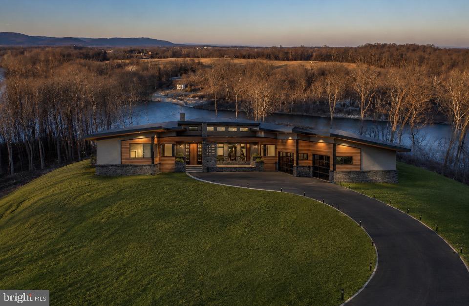 DEEP RIVER ACCESS! CUSTOM MID CENTURY MODERN CONTEMPORY RANCHER with picturesque views of the Potomac River, Dam 5 & Majestic Mountain views! Sited on a private 6.46 acre lot- this sprawling  2826sq ft home features - 3 bedroom 2.5 bath- 3 car garage side load -Open concept with  Soaring cathedral ceilings- Custom designer kitchen - Great room features a gas fireplace- low maintenance designer lvp flooring - This is a TO-BE-BUILT home- Master bath complete with freestanding tub and separate shower with rain head and handheld.  Builder has allotted for upgraded modern lighting fixtures. Upgraded quartz counter tops through out home-Large enclosed rear screened in porch-
Homesite sits at the end of a cul-de-sac in Bella Vista- a gated exclusive community consisting of only 11 homesites. 
Homesite 28 offers approx 500 ft of direct Potomac River frontage and dominates the end of the cul-de-sac (neighboring lots will position homes far away- creating exclusive & private location for a new home.) This direct frontage exclusive frontage is after Dam 5 which boosts some of the best fishing.  Community does also offers 150 ft of direct community river frontage above dam 5 with Pavallion & boat ramp- Deep River for boating! This piece of Heaven is only approx 80 miles to Washimgton DC/ 65 miles to Dulles Airport making its location ideal! Owner is a licensed Real Estate Broker.