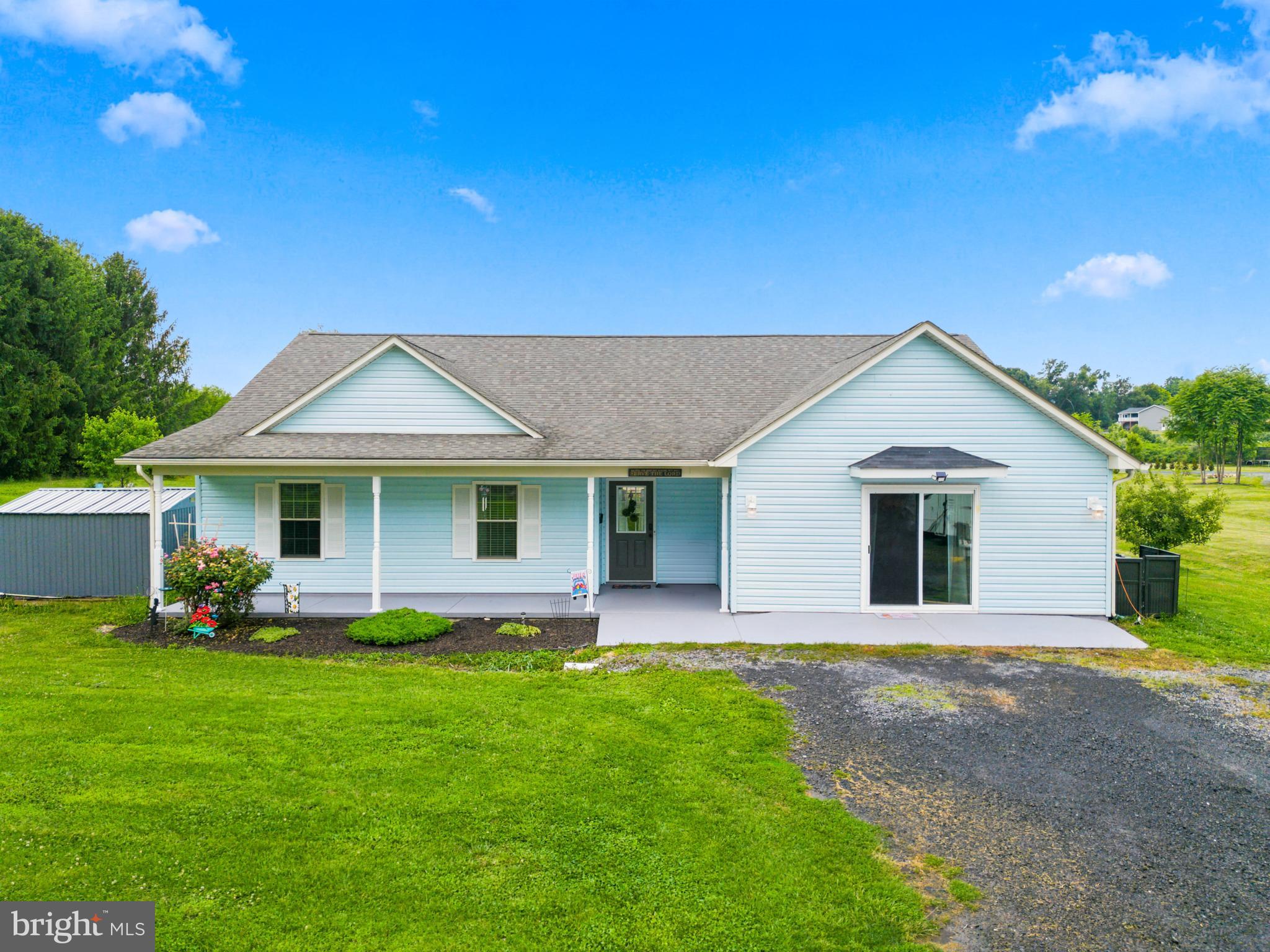 Welcome home to 1915 Readus Road, where peaceful country living meets modern convenience just minutes from I-81. Nestled on a beautiful lot with stunning mountain and countryside views, this well-maintained one-level home offers 3 bedrooms, 2 full bathrooms, and the perfect blend of comfort, functionality, and outdoor living. Start your mornings on the inviting covered front porch with a cup of coffee or unwind in the evening while enjoying the peaceful surroundings. Inside, the spacious living room features soaring ceilings, a cozy fireplace, abundant natural light, and large windows that showcase the beautiful backyard views. The kitchen offers stainless steel appliances, a farmhouse sink, and an updated faucet. Luxury vinyl plank flooring flows throughout the main living areas and the spacious primary suite, while the two additional bedrooms are comfortably carpeted. In 2023, the attached garage was professionally converted into approximately 400 square feet of additional finished living space with permits through Shenandoah County, creating the perfect family room, home office, playroom, or hobby space. Step outside to your own private retreat where the current owners have enjoyed raising chickens, turkeys, sheep, and goats. The backyard is both beautiful and functional, featuring a new gazebo, freshly painted concrete patio, mature peach, cherry, and two apple trees, a graceful willow tree, and a large shade tree. Additional improvements include a Kit barn and steel storage shed installed in 2022, an open shed for a mower or tractor added in 2023, a new Samsung dryer and chest freezer that convey, water heater replaced in 2025, and a new rear vinyl sliding glass door installed in 2026. If you've been searching for a move-in ready home with breathtaking views, thoughtful updates, and room to enjoy the country lifestyle, this property is one you won't want to miss.