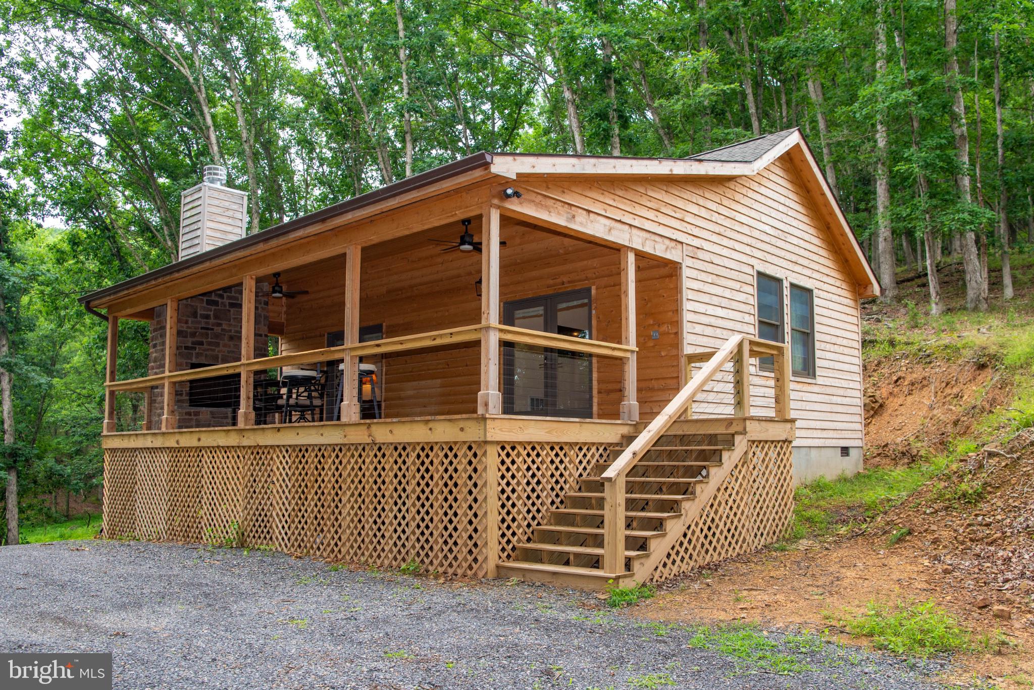 Built in 2025 and nestled in the beautiful Lost River Valley this charming 1-bedroom, 1-bath mountain retreat sits on just over 5 private acres and offers the perfect blend of comfort, simplicity, and outdoor living.
Relax on the spacious covered porch, gather around the outdoor fireplace, and enjoy the peaceful wooded setting throughout the seasons. Inside, the cabin features a thoughtful layout, modern finishes, and a dedicated laundry room for added convenience.
Located approximately two hours from Washington, D.C., this property is ideally suited as a weekend getaway, full-time residence, or potential vacation rental. Escape the city and enjoy privacy, fresh mountain air, and everything the Lost River Valley has to offer.