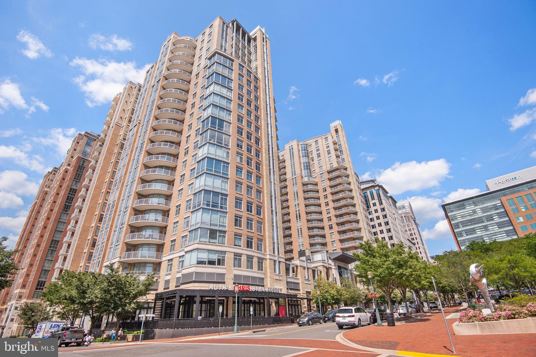 This stunning penthouse condominium is located in the West Building of Midtown at Reston Town Center and is in the heart of all the shops and restaurants that RTC has to offer. Situated across from the Reston Town Park, this sophisticated, light-filled unit has been fully renovated and features exceptional design elements throughout.  With stunning views from every room, this penthouse offers 2 large bedroom suites, a true gourmet kitchen, an elegant living/dining area with a custom designed fireplace and a handsome office.  The unit faces northeast providing spectacular treed vistas from the 3 balconies. Two deeded parking spaces just across from the garage elevator and two large storage units are included in this offering.  

Midtown at Reston Town Center has a gorgeous lobby with a cozy fireplace and sitting area, a well-equipped gym, an outdoor pool and 24/7 concierge services.  Enjoy the finest of penthouse living with all the offerings of Reston Town Center. Restaurants, shops, Metro and access to the W&OD Trail are just outside your front door. Dulles Airport is less than 4 mi away and 20 mi from our nation's capital.