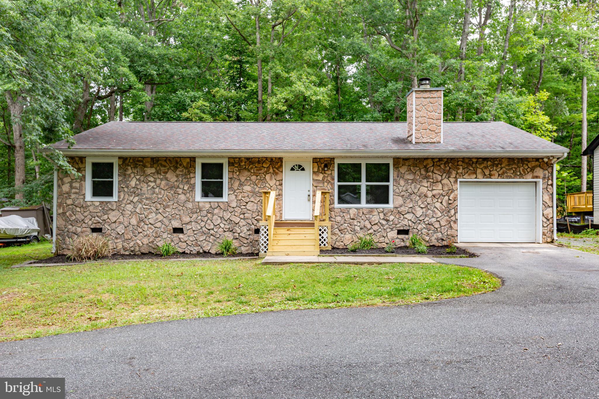 Completely renovated in 2026, this move-in ready 3-bedroom, 2-bath rambler offers modern finishes, thoughtful updates, and the convenience of one-level living in the sought-after gated community of Lake of the Woods. From the moment you arrive, you'll appreciate the horseshoe driveway providing ample parking, the attached one-car garage with additional storage, and the home's inviting curb appeal. Step inside to discover a bright, open layout featuring brand-new luxury vinyl plank flooring, fresh interior paint, all-new trim, recessed lighting throughout, and all-new windows that fill the home with natural light. The heart of the home is the beautifully redesigned kitchen, complete with brand-new cabinetry, quartz countertops, and a full suite of new stainless steel appliances, perfect for everyday living and entertaining alike. The spacious family room serves as the central gathering space, offering a comfortable setting for relaxing or spending time with family and friends. Both bathrooms and bedrooms complement the home's fresh, modern feel, while new front and sliding glass doors enhance both style and functionality. Outdoor living is equally enjoyable with a brand-new rear deck overlooking the private, wooded backyard, creating a peaceful retreat for morning coffee, evening gatherings, or simply enjoying nature. Stairs lead from the deck to the backyard, offering easy access to the outdoor space. Located within the amenity-rich Lake of the Woods community, residents enjoy a gated entrance, lakes, beaches, pools, golf course, parks, walking trails, equestrian facilities, clubhouse, dining, fitness center, tennis and pickleball courts, and a variety of year-round community events. The home is within walking distance of the lake and just minutes from shopping, dining, schools, and major commuter routes. With nearly every major cosmetic update completed in 2026, including new LVP flooring, trim, kitchen cabinetry, quartz countertops, appliances, front and rear decks, recessed lighting, windows, front door, sliding glass door, and fresh paint throughout, this home offers the perfect combination of modern style, low-maintenance living, and exceptional community amenities. Simply unpack and start enjoying everything this beautifully updated home has to offer.