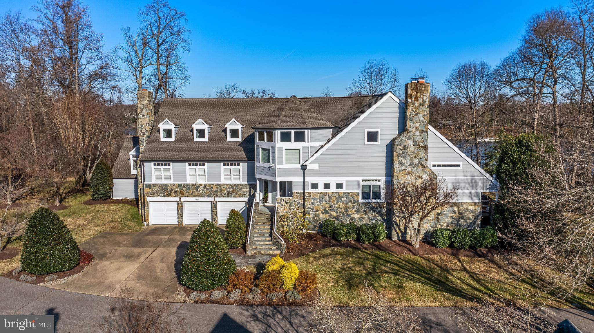 Spectacular waterfront property on the South River in the Poplar Point community w/ private pier with electrical service accommodating multiple boats (14-ft avg depth).  Remarkable design ingenuity and engineering virtuosity is displayed in this custom designed and built contemporary on the banks of the  South River. Built out from the 40-foot-on-center steel column, this distinctive architectural design features a soaring 28-foot wood planked main ceiling with exposed beams that crown the impressive main living spaces and boast walls of glass with water views. The recently renovated kitchen was impeccably designed to consider every need and "want" for the most discerning of chefs and boasts quartz countertops, fabulous cabinet/storage design, Wolf cooktop and double wall ovens plus a fabulous built-in banquette and dry bar. The dramatic Dining Room easily hosts your largest party next to an oversized fireplace and the tiered floor plan intentionally differentiates various gathering spaces, preserving both intimacy and openness. The Primary Suite features dual walk in closets, fireplace, wet bar and luxury bath.    Boasting major improvements such as: an architectural shingle roof, Hardie plank siding and bathroom and kitchen/dining room renovations. This home is an exemplification of expert engineering, function and breathtaking design. A remarkable specimen!