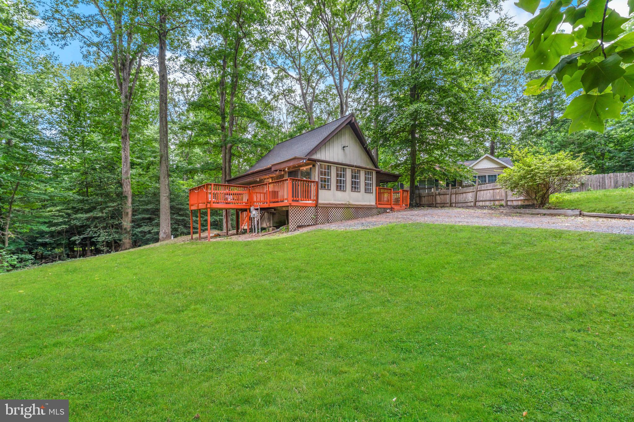 Welcome Home! This 3-bedroom, 2 full bath A-frame oasis perfectly nestled by a tranquil forest canopy offers a cozy, secluded living environment for family and guests.  Its soaring walls of glass flood the space with natural light while seamlessly blending indoor living with nature.  The expansive deck and porch are ideal for entertaining and provide an excellent vantage point to enjoy the peaceful sounds of nature while stargazing or enjoying quiet, private evenings in a treelined sanctuary.  The dramatic vaulted ceilings add design and provide a spacious feel to the living room and kitchen areas.  Come see and make this house your home!  This is an estate sale and is being sold AS IS.  NOTE: This property may be eligible for Special Financing programs that provide Buyers with low to no down payment options. Ask the lender for details.