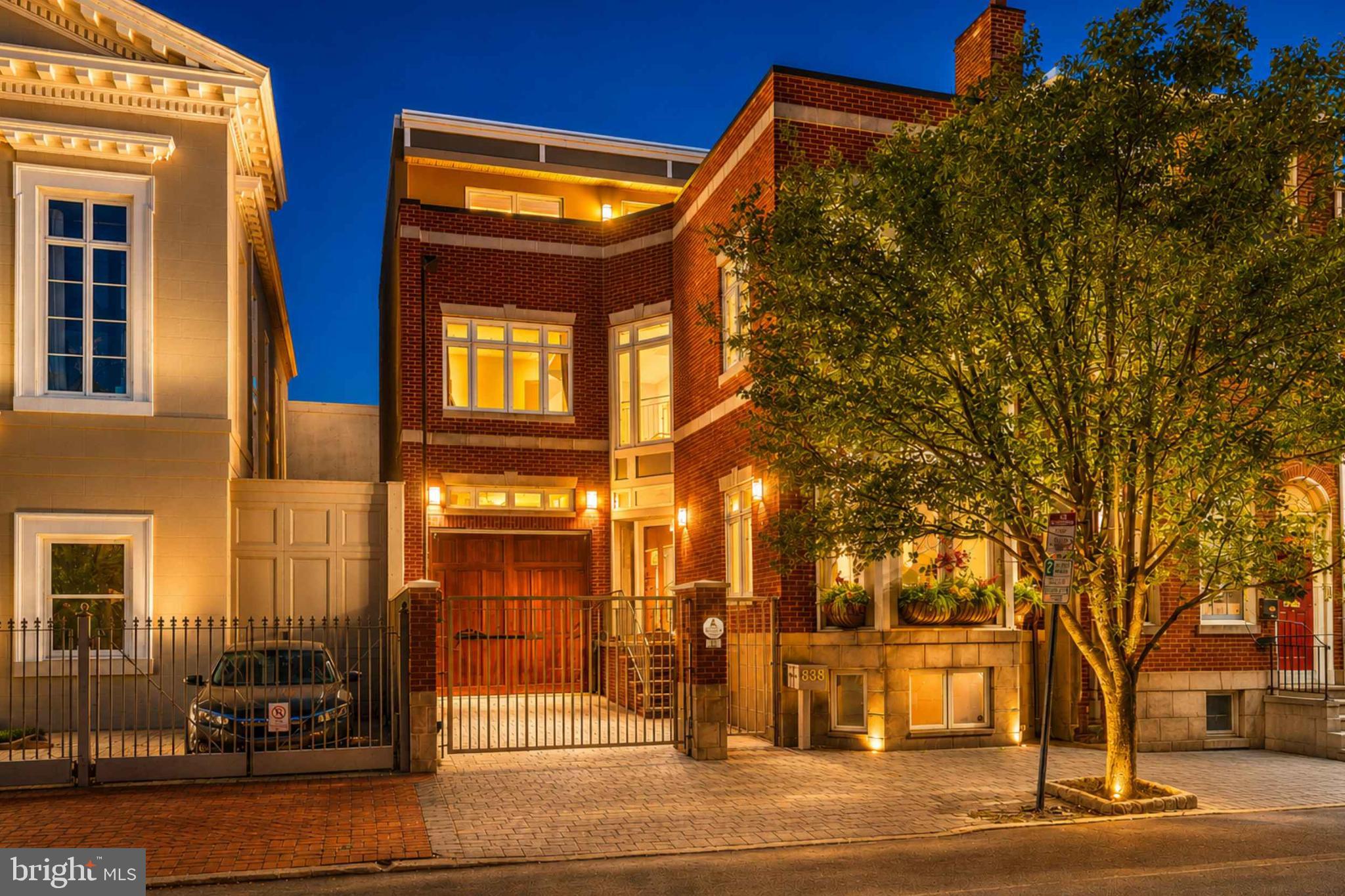 An Exquisite Washington Square West Residence.
A rare, 29-foot-Wide Double Lot in the heart of Washington Square West sets the stage for this extraordinary nearly 4,200 sq. ft. turn key contemporary residence. With its timeless  brick façade, oversized bay windows, Brazilian hardwood floors throughout, and gated courtyard entry & 2 CAR PARKING (GARAGE & GATED DRIVEWAY)  the property offers a commanding  presence . Once inside, meticulous updates and thoughtful design unfold in every direction, creating a home equally suited for gracious entertaining, comfortable family living, and the quiet enjoyment of refined city life on elegant tree lined street with 3  Outdoor Spaces !
At the core of the main level, a fully redesigned chef’s kitchen takes center stage. Outfitted with a classic Wolf range and wall ovens, panel-ready Sub-Zero refrigeration, Bosch dishwasher, immaculate quartz countertops, and every modern convenience, it is as functional as it is elegant. An expansive island with breakfast bar flows seamlessly into the dining and living areas, creating a natural centerpiece for daily life and a setting where gatherings, both large and small, feel effortless. Wide windows bathe the space in natural light, highlighting the home’s impressive scale and subtle architectural details.
The home’s rare width and ceiling height are felt on every floor, offering generously proportioned rooms and a sense of openness seldom found in city living. Multiple living areas allow for flexibility - whether as formal entertaining , casual family retreats, or creative spaces tailored to the owner’s lifestyle. A full-height elevator provides ease and comfort, connecting every level, from the lower-level in-law/au pair suite to the stunning rooftop terrace with sweeping views of the Philadelphia skyline.
The private quarters are equally remarkable. With five bedrooms and four and a half bathrooms, the residence adapts to every stage of life and style of living. The second floor primary suite serves as a elevated sanctuary , with space for a private sitting area, abundant natural light, a spa-like bath, spacious walk in closet and a private balcony that offers a place of calm and indulgence. An adjacent room off the primary suite and den overlooking the formal living room can serve as a perfect office, informal living room, library, or a convenient nursery and playroom, to name a few. Additional bedrooms provide comfort and privacy for residents and guests alike, while dedicated spaces include an upper-floor laundry room and an abundance of well-appointed closets and storage.
Outdoor living is as thoughtfully designed as the interiors. A gated front courtyard welcomes with elegance and privacy, while the expansive rear patio and rooftop terrace provide opportunities for dining al fresco, quiet reflection, or lively entertaining against the backdrop of city lights.
Every detail of this residence reflects a balance of history and modernity, permanence and comfort. The timeless architecture grounds the home in tradition, while careful updates ensure it meets the demands of contemporary living. Its scale, width, and flexibility allow it to function beautifully for both intimate daily life and grander occasions. The property is complete with the convenience of a gated driveway, oversized attached garage with EV charger, and an additional private staircase to the lower-level in-law suite. Perfectly located within the sought-after McCall School catchment and just seconds from the finest dining, shopping, and cultural experiences of Washington Square West , this home embodies the essence of Philadelphia living at its most distinguished.Contact listing agent Justyna for private tour!