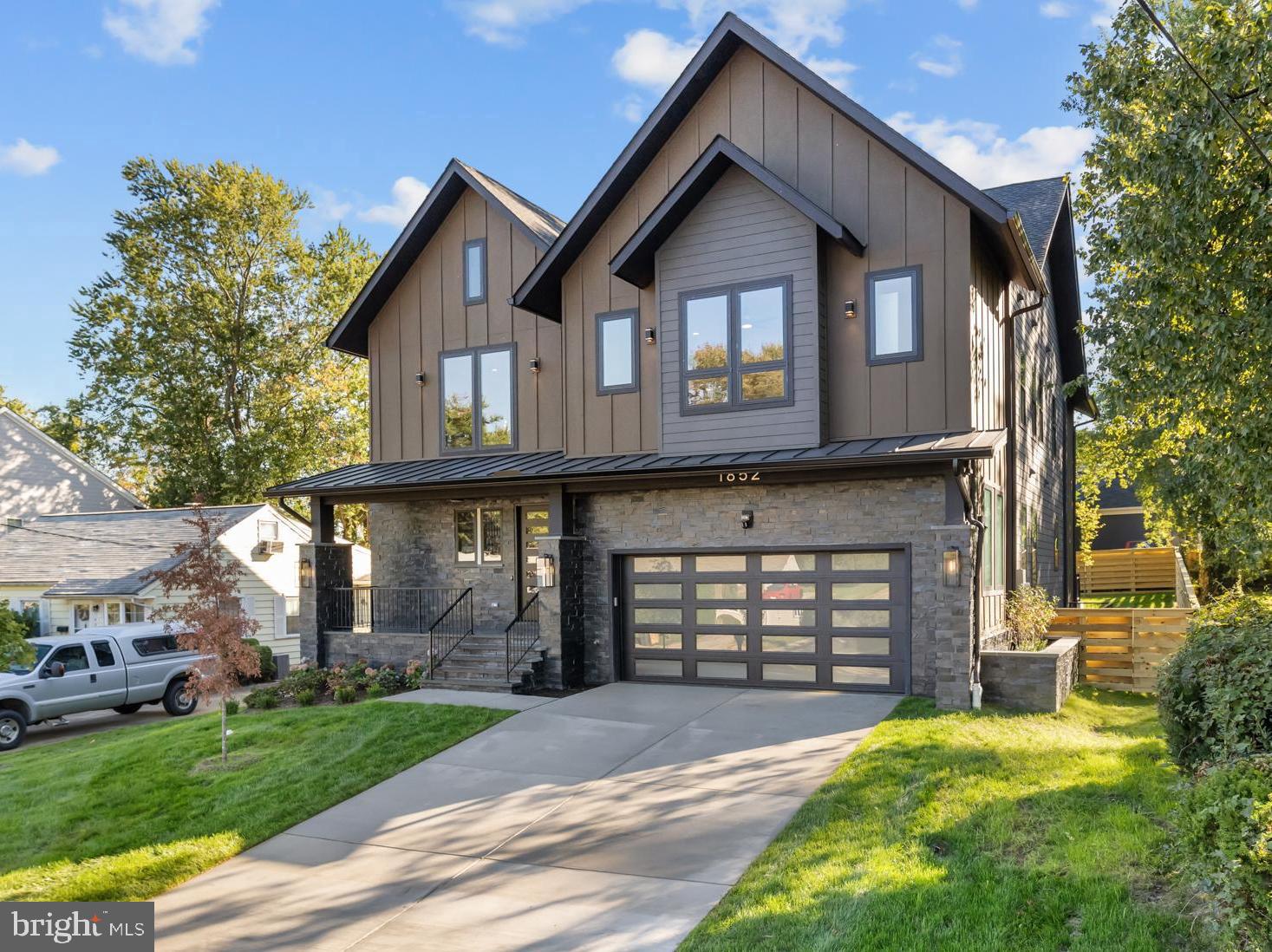 Welcome to another magnificent project by Gilkar Design + Build. *** 6 bedrooms, 6 full baths and 2 half baths, ELEVATOR with stops on all 3 levels, 7,000+ sqft. The main level boasts a beautiful double-height foyer, 10' ceilings, 8' solid wood doors and cased openings, and hardwoods throughout. Elevator with stops on all 3 levels. Open concept kitchen/living, and large library/office/formal sitting with french doors. A stunning kitchen design with a KitchenAid appliance package, ample cabinetry to the ceiling, floating shelves, a separate large and well lit pantry, and a large kitchen island with seating and a tray ceiling. A large gas fireplace with a stone surround, with tray ceiling, and tons of windows rounds out the living room. A formal dining space with tray ceiling, additional cabinets and stone feature wall, deck with built-in gas and hot/cold water lines, an oversized 2-car garage with 1 EV car charger and WiFi irrigation control. A functional mudroom with a compact washer and dryer (1 of 3) *** The upper level has the primary bedroom which boasts a tray ceiling, a giant ceiling fan, walk-in closet with island, and a wet bar. A jaw-dropping primary bath with rain shower heads, free-standing tub with faucet, and double vanity with ample cabinets. An additional three bedrooms with walk-in closets and full private bathrooms are down the hall. Second-floor laundry room has a high-capacity washer and dryer with a sink and extra cabinetry space (2 of 3). Hardwood floors throughout the second floor. *** The lower level is fully finished with side walk-up, a wet bar with wall cabinetry and a peninsula with seating, a full-size stainless steel refrigerator, and a dishwasher. A large recreation/media room with 2 additional bedrooms, 2 full baths, and 1 half bath. LVP floors throughout the lower level. Basement laundry has a high-capacity washer and dryer with a sink (3 of 3). *** Additional features include 2” thick stair treads, millwork throughout, plumbing manifold system, hot water recirculation system, and above-code insulation. Solid wood doors, ceiling fans, LED lights, LED stripe tape lights, and Smart features throughout. Underground irrigation system. Verizon Fios is run to the house and router and VOIP located in the mechanical room. Extra WiFi extender points on upper and main level. Ring video doorbell and 4 Ring security cameras convey with house. Close to Tysons, Vienna, and Falls Church, with a great selection of restaurants and shopping to suit everyone's needs. Easy access to 495 and 66.