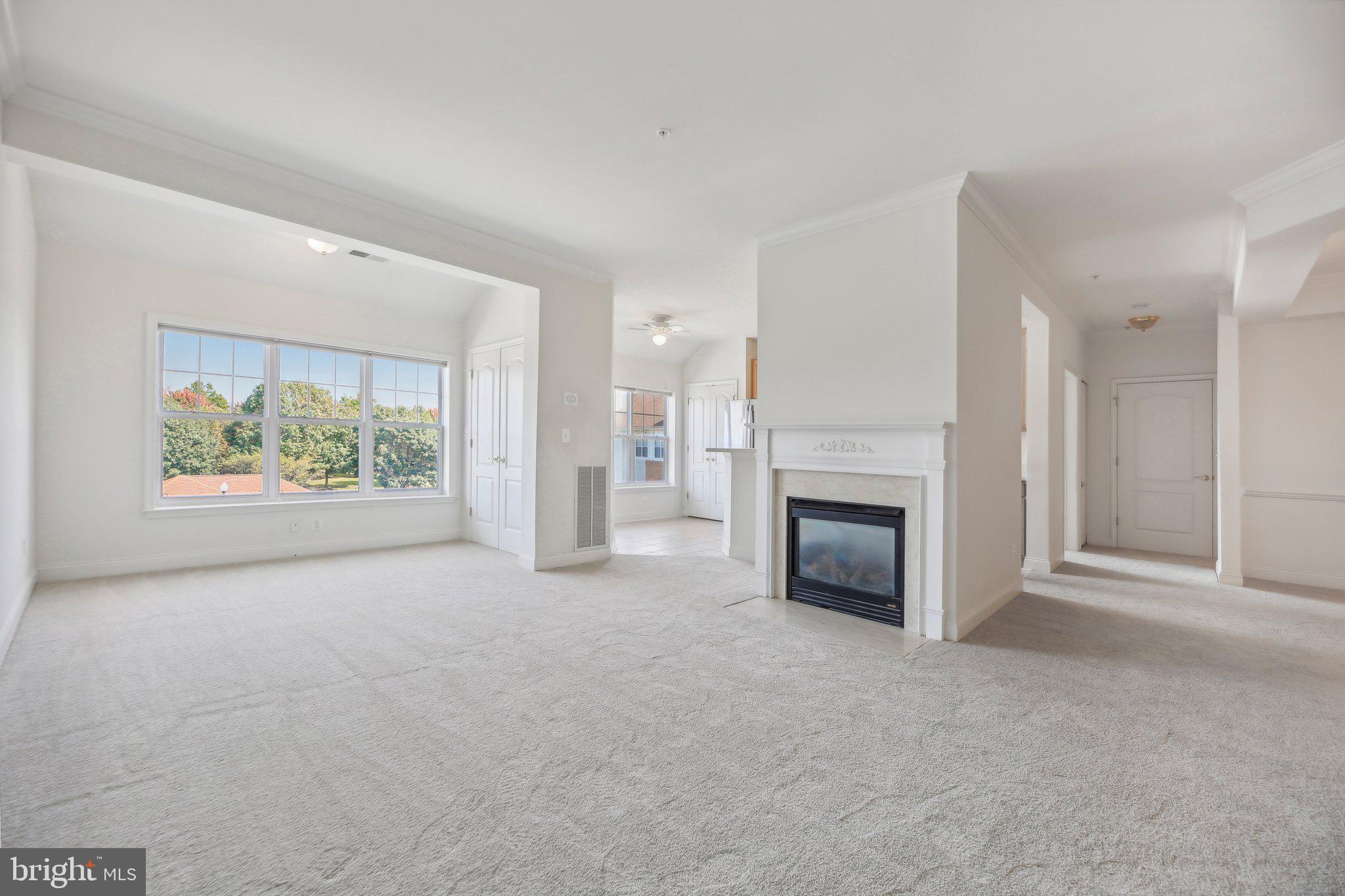 Welcome home to a beautifully maintained 2-bedroom + office condo offering a spacious and light-filled top-floor living experience AND a separately deeded garage! This lovely home features new carpet and fresh paint (both updated in 2024), a cozy fireplace, and a functional kitchen with a refrigerator replaced in 2022.  Enjoy added peace of mind in this secure building with extra storage space on the ground floor.  This is NOT a 55+ community. Centrally located close to grocery stores, restaurants, and a golf course, this condo provides a perfect blend of comfort and convenience. Don’t miss out on this move-in ready gem! Schedule a tour today!