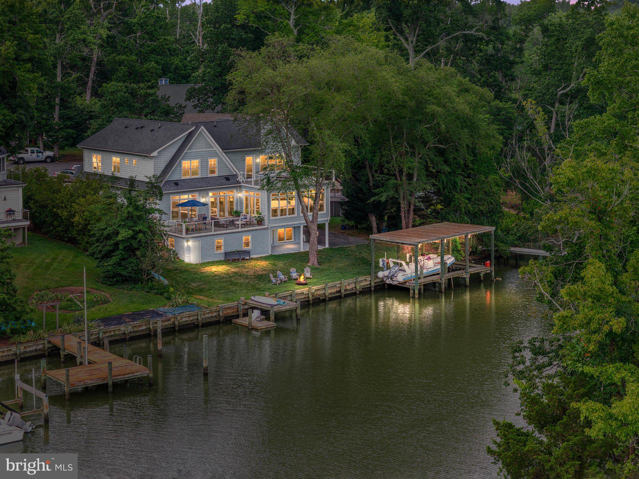 Annapolis Stunning Coastal Colonial Waterfront Retreat where every day feels like a vacation.

Perfectly positioned on the tranquil waters of the Chesapeake Bay tributaries, this extraordinary waterfront residence at 529 Lee Circle offers an exceptional blend of sophisticated coastal design and effortless indoor-outdoor living. Privately nestled among mature trees, the home enjoys a peaceful setting with panoramic water views, a private pier, a boat house and a floating dock, creating the ultimate Annapolis waterfront retreat.

The impressive rear elevation is designed to embrace the waterfront lifestyle, featuring expansive walls of glass that flood the interiors with natural light while framing picturesque water views from nearly every level. Multiple outdoor living spaces—including a spacious waterside deck, an upper-level balcony, and an expansive lawn leading to the 114 feet shoreline—provide the perfect backdrop for entertaining or relaxing while enjoying spectacular sunsets.
The boat house with lift, private pier, and protected water dockage offer immediate access to boating, paddleboarding, kayaking, and all the Chesapeake Bay has to offer. Whether departing for a day on the water or enjoying quiet evenings along the shoreline, this property delivers an unmatched waterfront experience.

Architecturally, the home combines classic coastal elegance with contemporary comfort. Soft gray siding, crisp white trim, multiple gables, and oversized windows create a timeless façade that complements its natural surroundings. The residence offers approximately 6,000 square feet of living space with two owners suite (one on the main level), generous entertaining areas, multiple fireplaces, and luxurious accommodations designed for both everyday living and grand-scale gatherings. The home was originally built in 1965.  In 2016 it went through a complete, down-to-the-studs renovation and expansion to the creation of stunning luxurious waterfront home.  Custom-Built by Architect Teresa Todd and Timberlake Homes into a 6-bedroom and 5.5-bathroom residence.  

Located within the sought-after Hillsmere Shores community, residents enjoy a coveted Annapolis lifestyle with access to a private beach, marina, community pool, playgrounds, and convenient proximity to Historic Downtown Annapolis, waterfront dining, yacht clubs, and the U.S. Naval Academy.  

This is more than a waterfront home—it is a private Chesapeake Bay sanctuary where luxury, recreation, and timeless coastal beauty come together in one exceptional offering.