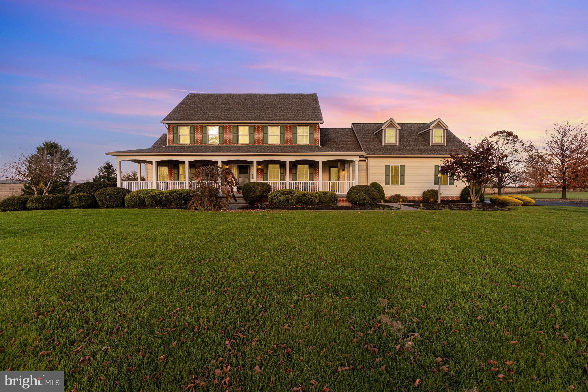 This 10 acre property in Lititz offers you incredible views from the large covered front porch, whether watching the sunrise or sunset, or enjoying coffee or iced tea on a rocking chair mid afternoon. Set back from the road, this stately brick home has a country/farm house feel and emits a welcoming glow when the porch lights and window candles are lit in the evening. As you enter the long driveway you will see that the driveway was well thought out with a built in roundabout, while still leaving plenty of room for parking or to have a friendly game of basketball. Inside there are 4 bedrooms and 3.5 bathrooms, featuring a first floor primary bedroom with large walk in closet and bathroom with double vanity.  This house was custom built with family gatherings in mind. Whether it's extended family for a holiday dinner, or friends who have become family joining you for a game night, the main floor entertaining space is welcoming and comfortable. With additional finished space in the daylight walkout basement you can spread out your entertaining onto two levels! Who can pass up the well maintained lawn and mature landscaping this property offers with a lower property tax assessment through clean and green, in addition to opportunity for farming revenue. While we could go on and on forever about why this is the ultimate dream home... with things like a New roof, water softener and UV light, sump pump, radiant floor heat throughout perfect for those cold winter mornings, and central vac that extends to the garage making cleaning out your car easy no matter the weather... You really should see this incredible property for yourself!
