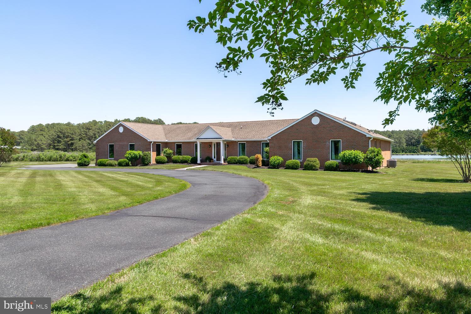 This exceptional 47± acre waterfront farm is located just outside Historic St. Michaels, offering a rare combination of productive farmland, extensive improvements and water views across Leadenham Creek. Encompassing approximately 42± tillable acres, the property is ideally suited for agricultural use, hunting and a serves as a stunning waterfront retreat. A tree-lined blacktop drive leads to the beautifully renovated brick main residence. Updated in 2017, the 3,500± square foot home is filled with natural light and thoughtfully designed to capture the property's attractive waterfront setting. Luxury vinyl plank flooring flows throughout the open-concept floor plan, where expansive windows frame sweeping views of the creek and surrounding farmland. The spacious kitchen, features white cabinetry, quartz countertops, stainless steel appliances, a large center island with bar seating, a beverage bar and a dining space suitable for a large farmhouse table. The adjoining living room provides comfortable everyday living, while the waterside family room is the heart of the home, serving as a showpiece with cathedral ceilings, exposed wood beams, skylights, a gas fireplace and floor-to-ceiling windows creating a seamless connection to the waterfront landscape and farm fields beyond. The waterfront primary suite offers a luxurious en-suite bath featuring dual sink vanity, a glass-enclosed tile shower and a spacious walk-in closet. Three additional guest bedrooms provide ample accommodations, complemented by a full bath with a dual sink vanity. A waterside office with pocket doors offers flexibility as a sitting room or space for additional guests. Completing the home is a large mudroom/laundry room, abundant storage space, an additional full bath and an oversized two-car garage. Outdoor living is equally impressive. A rear patio leads to the waterside in-ground pool surrounded by expansive hardscaping, creating the perfect setting for entertaining or relaxing while enjoying the tranquil views. The private dock, equipped with electric and a boat lift, provides direct access to the creeks, rivers and surrounding tributaries of the Chesapeake Bay. A separate 2,700± square foot guest house offers even more versatility, featuring 3-4 bedrooms and 2-baths. Ideal for extended family, guests, farm staff or potential rental income, it provides comfortable accommodations while maintaining privacy from the main residence.  Supporting the farm operation are numerous outbuildings, including a substantial 40'x60' enclosed equipment barn with electric, plumbing and a 12’x30’ open lean-to, a 50’x120’ open equipment building and a 24'x40' barn with attached 12’x24’ lean-to. Once operated as a beef farm, this versatile property presents endless opportunities for farming, livestock, equestrian use or the creation of a multi-generational family compound. Currently leased and farmed by a local farmer, the tillable acreage allows owners to enjoy the charm and scenic beauty of a working farm, along with the agricultural tax benefits without the time commitment and responsibilities of the farm operations. For hunters and outdoor enthusiasts, the farm offers excellent habitat for deer, turkey and geese, while the waterfront location provides easy access to boating and fishing. Properties rarely come available that offer this combination of acreage, waterfront, extensive improvements and a prime location just minutes from the shops, restaurants and the maritime charm of downtown St. Michaels. This is Eastern Shore living at its finest.