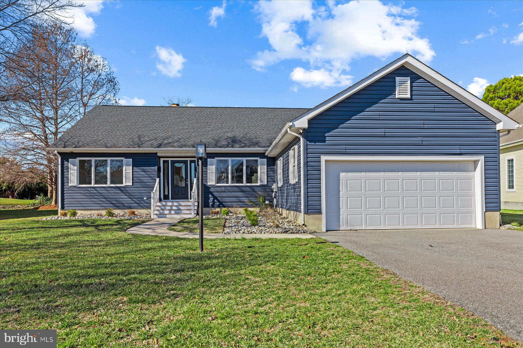 Completely renovated, this one story home lives like a brand new property and offers incomparable views of the golf course in the amenity rich community of The Salt Pond.  Step through the glass front door into the combination living, kitchen and dining area which is flooded with natural light.  The brand new, yet timeless kitchen blends crisp white cabinetry and counters with a beautiful, warm toned island that offers ample storage and seating.  Three windows placed above the kitchen sink bring in the outdoors and allow natural light to spill throughout the room.  The kitchen flows into the living area with a beautiful white brick fireplace that has built in counters and cabinets on either side, plus a wet bar complete with a wine fridge and custom shelving.  No detail was spared as this area mirrors the high quality finishes and design of the kitchen and the rest of the home.  Step through the sliding glass doors to a large deck for dining with spacious views of the course.  Adjacent to the kitchen, a large dining area with oversized windows completes this space.  The primary suite, also positioned to take full advantage of golf course views, features a large walk-in closet with custom cabinetry and a modern en-suite bathroom with dual sinks, glass shower and heated towel rack.  On the opposite side of the home, you will find two additional bedrooms with a shared full bathroom, complete with a shower and tub combo.  The 2-car garage provides plenty of space for your golf and beach necessities and it leads into the laundry room and adjacent powder room.  Positioned among the natural beauty of wetlands and ponds, and less than a mile from the ocean, The Salt Pond offers indoor and outdoor pools, tennis courts, a children's play area, a community kayak launch, a community recreation center, and a mid-length, executive 18-hole golf course and more.