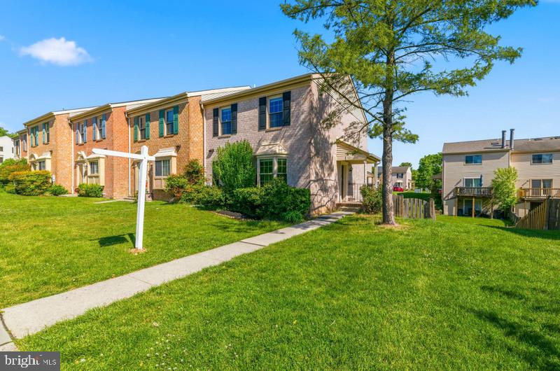 OFFERING A $5,000.00 SELLER CREDIT! Fantastic end-unit townhome offering three levels of spacious, comfortable living. The main and upper levels feature beautiful hardwood flooring, a bright and open kitchen/dining area, a convenient half bath, and a welcoming living room with direct access to the rear deck. A private side entrance adds extra convenience and charm. The extra‑large, fully fenced backyard provides exceptional outdoor space—perfect for relaxing, entertaining, or pets. The upper level includes a generous primary suite with a large walk‑in closet and full bath, plus two additional bedrooms and a full hall bathroom. The finished lower level offers a spacious family room with walkout access to the oversized backyard, a bonus room ideal for an office or guest space, and a utility/laundry room. Excellent location close to local amenities, commuter routes, and everyday conveniences.