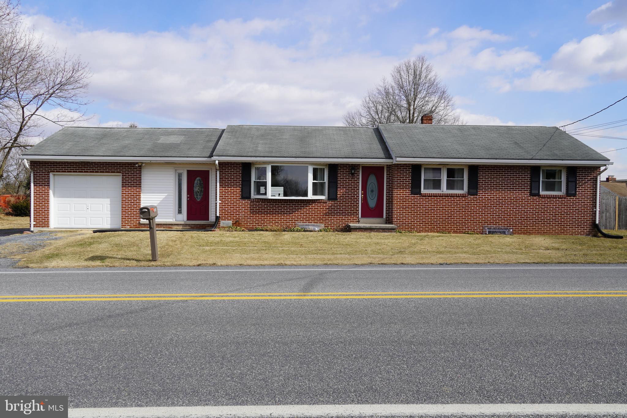 Fall in love with this all brick ranch home!!! This home includes 3 bedrooms and an updated kitchen and main bathroom! Enjoy the 1st floor laundry,  half bath, and heat pump with central air that were added in 2015! Relax in the back yard that is completely fenced in.  The home also comes with an attached one car garage, a detached two car garage, and a large driveway for additional parking.  Commercial zoning is possible.  Currently zoned Suburban Residential which allows the owner to operate a business out of the home. Don't wait, this home be yours!