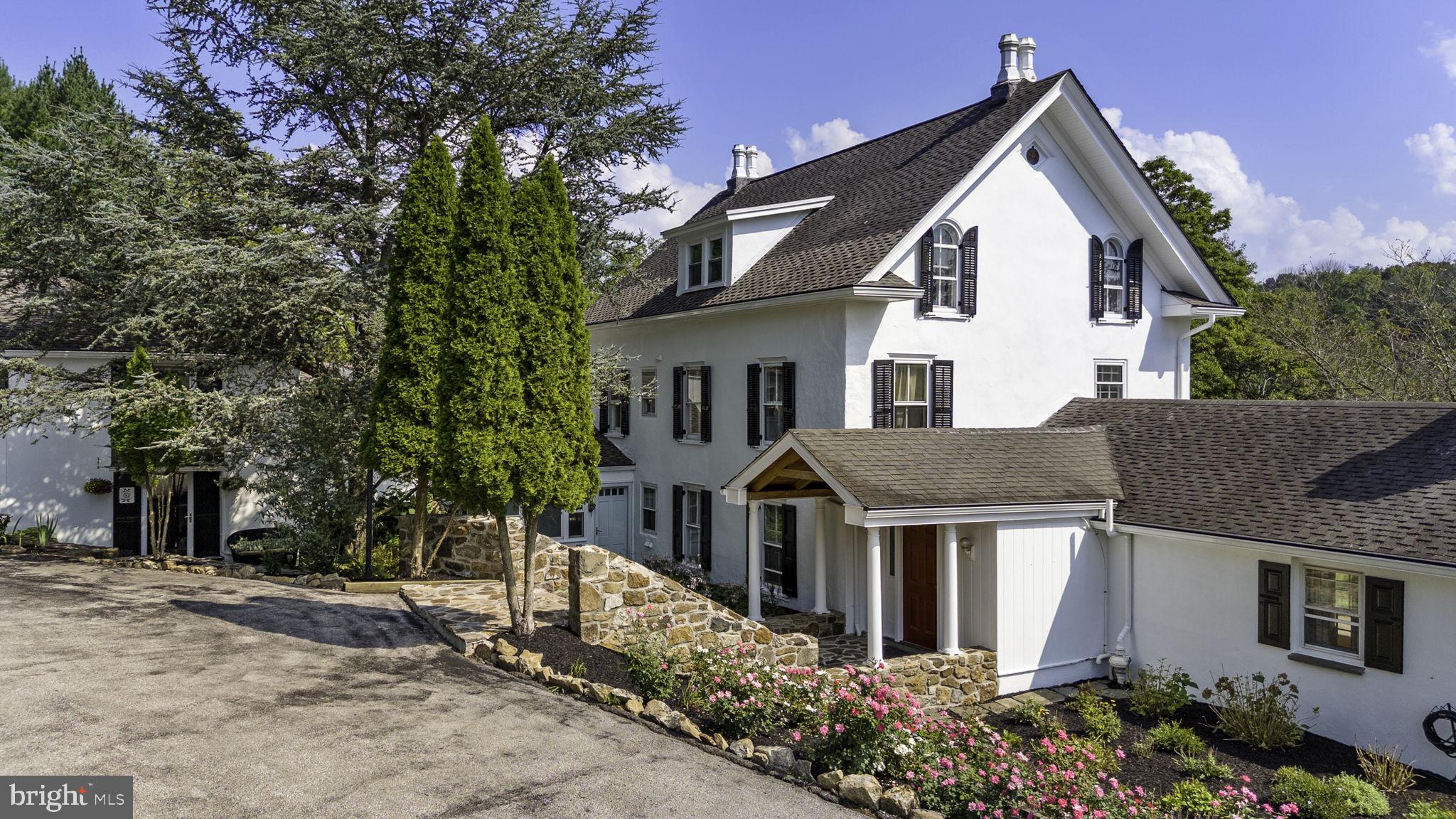 Beautiful farmhouse originally built in the late 1700s is nestled in the heart of a picturesque landscape. Property is part of the ACT 319 designation and offers super low taxes under $5200.00!  
Inside you are greeted by the warmth of random width hardwood floors that flow throughout the interior, creating a timeless ambiance.   The cozy Great Room has a large wood burning fireplace with marble surrounds, flanked by built ins and large french doors that open to the patio offering views of the gardens and pastures. Random width wood floors, pocket doors, built in Bookcases and fireplaces are only some of the farmhouse amenities here. The kitchen opens to a large dining area and connects to a sunroom and outdoor stone patio.   Upstairs on the second floor, the primary suite and completely renovated en suite bathroom offer a serene place to unwind at the end of the day.  A second bedroom and hall bath as well as laundry closet complete the second level.  The third level offers a full bath and 3 additional bedrooms .  A family room/ den area connects the main home to the renovated  carriage house on the first level with the option of separation by closing the door. This room has exposed beams and a large historic wood burning fireplace. The carriage house has its own private entrance and lots of great space perfect .  The main floor has a large closet for storage and utilities, a half bath, and an open floor plan kitchen/ living / office space.  Upstairs the primary suite is spacious and bright with sweeping views on multiple sides.  A full bathroom and additional bedroom with laundry gives you everything you need and more!  
On the property, the expansive pastures surrounding the property offer endless possibilities for those with an equestrian or farming passion, providing ample space for horses or agricultural endeavors.
A standout feature of this estate is the meticulously maintained Stone bank barn. The barn provides abundant storage and potential for various uses. A newly added screened porch area on the first level of the barn is perfect to enjoy the evenings after a long day.  Inside the first level of the barn are 12 horse stalls, a tack room, a feed storage room, heated wash stall, powder room, gorgeous stone office, a craft or project room, a large storage room for equipment and the detached garage.  The 2 story floored second level of the barn with access to the second level deck overlooking a sand riding arena  and views of the sunsets. This space offers so many possibilities!  
Some upgrades done here include rebuilding and repairing the roof line, new gutters and downspouts, exterior chimney rebuilt with new liner, new primary bathroom, water purification system, full radon system, freshly painted inside and out. New Septic Pump, new well pump, new washer dryer in main house and reported outdoor stone firepit. The cottage was completely renovated from top to bottom, mini split systems added and more.  See attached documents for more information.
