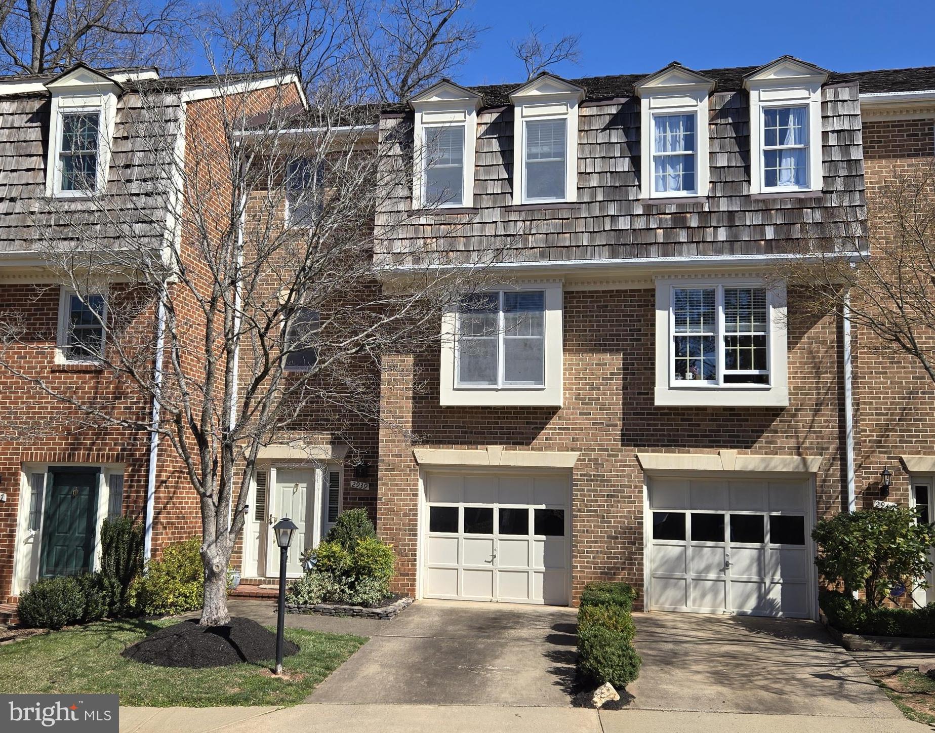 Fabulous brick garage townhome in beautiful condition!!!  Welcoming foyer with open wood staircase to main level.  Wonderful large living room overlooking rear yard and trees.  Formal dining area with hardwood floors.  Gourmet kitchen with stainless steel appliances, granite, light-cherry cabinets and tile flooring.  It also has recessed lights and one of the four ceiling fans.  There is a handy main level powder room and laundry on this kitchen level, as well!!!  Great upper level primary suite with its own private bath.  Three total bedrooms upstairs and large secondary full bath.  The entry level has a terrific recreation room with wood-burning brick fireplace and also a second powder room.  There are French doors to the fully-fenced "Georgetown Courtyard" with a slate patio, stone wall and beautiful plantings.   This amazing garage townhome is all ready for you!  (Dining room chandelier can be reinstalled.)  Close to Town of Vienna, Tyson's Corner, I-66, the Beltway, the Orange Line Vienna Metro stop, Reston and the entire technology corridor.