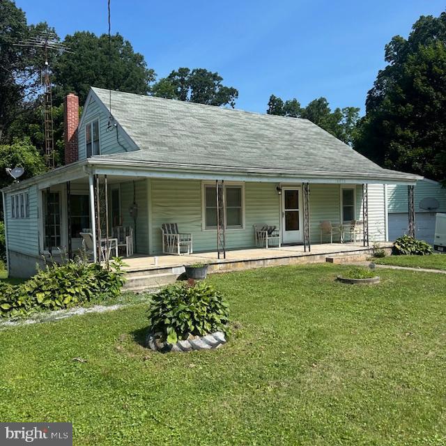 Unbelievable potential in this cute cape cod style home sitting on just shy of 6 acres. This home has so many great features to include a wrap around front porch, huge oversized detached garage/workshop large enough for 4 cars, hardwood floors, large kitchen with newer stove and refrigerator, first floor master suite, upper level with 2 large additional bedrooms, and a huge unfinished basement . There's a lot of space here to create your dream home!  Estate sale, being sold AS-IS.