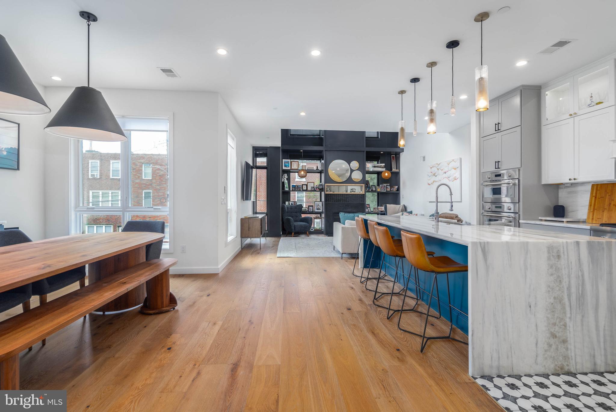 A Home Buyer is often left with tough decisions to make during their house hunt. Can we live without parking? Is the home too narrow? Can we live without a backyard? All of these questions and concerns can be left at the door of 2055 E Dauphin. Welcome to the Unicorn of Fishtown. Located on a massive 27' by 85' lot, this custom-built home was envisioned by GNOME architects and designed by rj lowercase. Square footage is no problem here - over 4,200 sqft of interior space spans the wide-open floor plan. Comfortably park in your GARAGE or driveway and enter this gorgeous foyer outfitted with chevron pattern brick floors and timeless trim work. The rear of your first floor includes a beautifully appointed office or bedroom with access to a full bathroom. The lower level is primed for entertainment - with MASSIVE 12' ceilings, this space is enormous for game days, movie nights or even your at home golf simulator (wiring already set up for projector!). This level is also decked out with a bar, wine room, and a special surprise you just have to see.  The 2nd floor is truly special. A custom chef's kitchen with the highest level of appliances centers the area, but the 2 story living room is the cherry on top. Incredible light fills this space and on cold days, enjoys the gas fireplace. It is the perfect four-season room. The floor is emphasized with another bedroom, bathroom, and a large outdoor patio - perfect for grilling and dining. The third floor of your designer home features a secondary bedroom bathroom, and laundry. But then you walk into your gorgeous primary suite and you may feel you have walked into an exclusive five star hotel. Adorned by a beautiful trim work and colors, this space includes 2 large walk-in closets and a magazine-worthy bathroom suite. Best for last, the outdoor spaces at 2055 Dauphin are a standout - no need to move to the suburbs to get the land you want! The rear yard is MASSIVE with beautiful greenery and turf grass - perfect for four-legged fur friends or kids. The roof top deck features multiple seating areas with center city skyline views. All these features in this home only STEPS away from Frankford Ave. There truly is too much to list for 2055 E Dauphin. Schedule your private tour today!