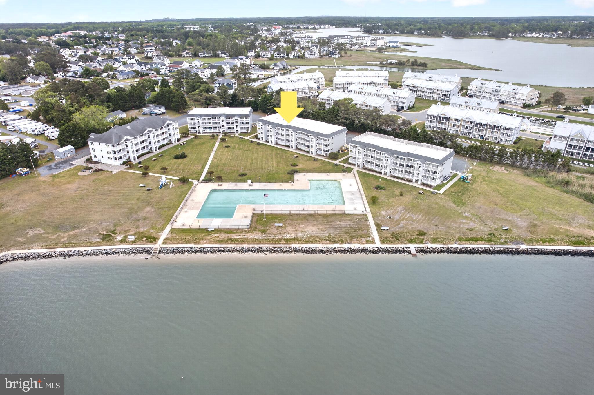 Coastal waterfront living awaits in this rarely offered 2-bedroom, 2-bath third-floor condo in the sought-after Cedar Shores community overlooking the scenic Indian River Bay. Offering approximately 900 square feet, this light-filled residence combines relaxed beach style with breathtaking water views and exceptional community amenities just minutes from Bethany Beach. The open-concept family room flows seamlessly into the dining area, both perfectly positioned to capture stunning bay and bridge views from the private balcony. The kitchen features light coastal tones that enhance the airy beach-inspired feel while opening directly to the main living space for easy entertaining. The spacious primary suite includes a sitting area and abundant natural light, while the generously sized second bedroom also enjoys bright, welcoming views. Recent carpet updates add fresh appeal throughout the home. Cedar Shores offers direct bay access with a convenient ramp for kayaking, paddleboarding, canoeing, and other water activities right from the community’s backyard. Residents also enjoy personal kayak and paddleboard storage racks, a large Olympic-size swimming pool—one of the largest in Delaware—and seasonal community gatherings that create a true coastal neighborhood atmosphere. Additional recent improvements include a new roof installed in September 2022 and a newly updated 2023 building facade with new siding on the parking lot side. Ideally located just minutes from Bethany Beach, dining, shopping, and local attractions, this is a rare opportunity to own a waterfront retreat with panoramic Indian River Bay views.