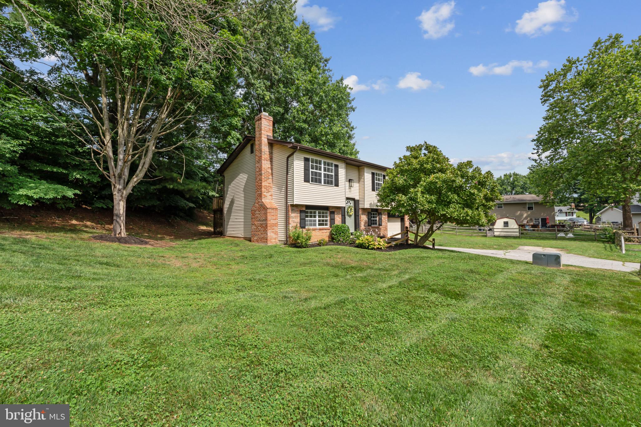 Beautifully renovated split-foyer residence offering 4 bedrooms, 2 bathrooms, and 1,344 finished square feet in established Carrolltowne. Step inside the freshly renovated interior, where 2026 updates include newly installed luxury vinyl plank flooring throughout the main-level living spaces, fresh paint throughout, and windows scheduled for replacement during the week of July 13, 2026. The welcoming foyer ascends to the main level, where a spacious living room seamlessly flows into an adjacent formal dining room, complete with sliding glass doors to the rear deck for effortless indoor-outdoor living. The stunning completely remodeled eat-in kitchen showcases upgraded quartz countertops, crisp white cabinetry, stainless steel appliances, and a cozy breakfast nook- the perfect space for a bistro table. Continuing on the main level, find a beautifully renovated full bathroom and three newly carpeted bedrooms, including the generously sized primary bedroom. The lower level expands the home's living space with an expansive, newly carpeted family room centered around a cozy brick-adorned wood-burning fireplace. This level also includes a fourth bedroom accented by a stylish feature wall, a second full bathroom fully renovated in 2026, and a laundry room with additional storage space for everyday convenience. Outside, enjoy a spacious backyard featuring an elevated deck, a patio, a storage shed, and additional side yard space for recreation or gardening. Completing the property are an attached one-car garage and a driveway with parking for four additional vehicles. Residents of Carrolltowne enjoy access to community common grounds, picnic areas, and tot lots/playgrounds, providing wonderful opportunities for outdoor recreation and neighborhood enjoyment. ALL WINDOWS WILL BE REPLACE THE WEEK OF July 13 due to scheduling issue.