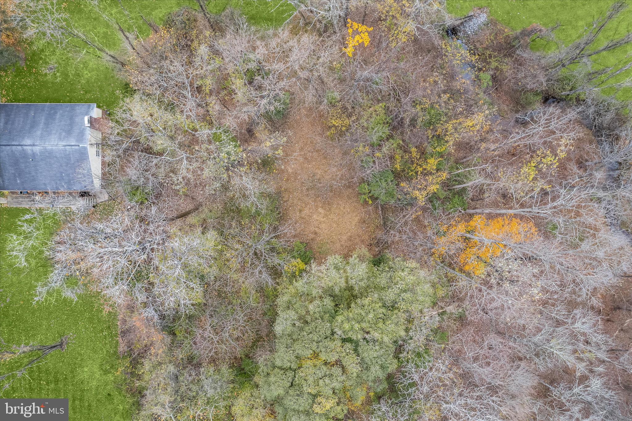 Beautiful wooded lot with clearing for your home. This lot cannot be subdivided because the left side of the property has a floodplain areaway. Please refer to the Floodplain mapping provided by the county. The buildable area sits above the floodplain area. There are no HOA fees- there is public access to water and sewer. There is NO builder tie in. No walking onto the property without an appointment. Buyer to verify all building areas for this lot.
