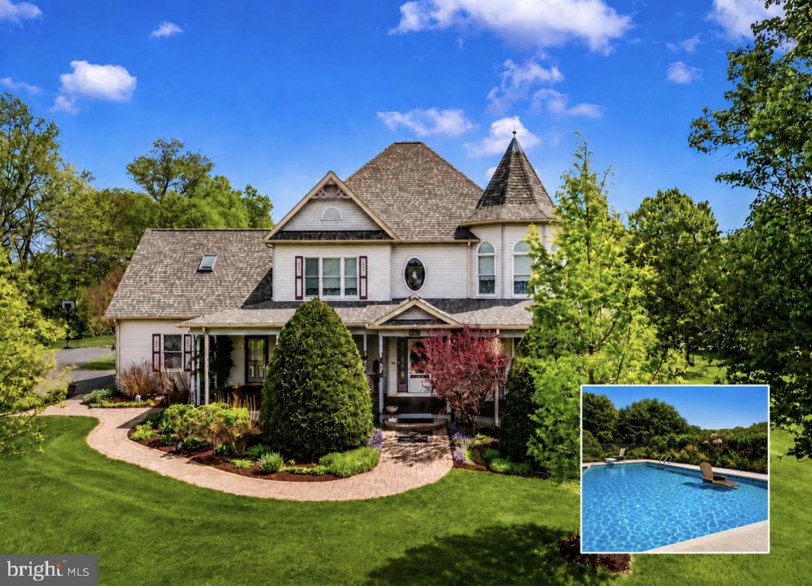 Paradise FOUND!!! Cast your eyes on this perfect, custom built Victorian home, meticulously maintained, and  artistically placed on a large private 2.2 acre lot with neighboring land preserved in a conservation easement—ensuring lasting privacy and uninterrupted natural views, all less than 1/2 miles from the C&O Canal!
From the moment you arrive, the long paved driveway, commanding presence of the home, and breathtaking grounds set the tone. A classic wrap-around porch constructed of tongue and groove Spanish cedar decking  enhances the home’s timeless character, offering the perfect place to relax and take in the peaceful surroundings. The landscaping is nothing short of extraordinary, thoughtfully designed to offer beauty in every season. Mature plantings, abundant hydrangeas, and carefully layered gardens provide waves of color and texture from spring through fall, with evergreens and structural elements creating year-round visual interest. Pristine, manicured views surround the home on all sides, creating a serene, resort-like setting.
The in-ground pool is a stunning focal point, evoking the feel of a private vacation retreat and resort haven—perfect for relaxing or entertaining. Lush landscaping frames the pool area beautifully, enhancing both privacy and atmosphere.
Inside, the home is bright, airy, and beautifully appointed, featuring a dramatic two-story foyer, two staircases, and pristine real hardwood and Italian porcelain tile with radiant heating throughout. Finer details include custom beaded trim throughout, accented with plinth blocks, rosettes, inside and outside corners. The primary bedroom includes a relaxing seating area inside the turret and the primary bath is the perfect spa atmosphere.  Sun-filled living spaces flow effortlessly, including a charming sunroom—ideal for morning coffee or quiet evenings while overlooking the beautifully landscaped grounds. The three bedrooms are extra large and the attic could easily be the fourth! There are no properties to compare! Come get it while it lasts!!

The heart of the home is the top-of-the-line kitchen, showcasing a custom Palmer kitchen  and Hess cabinetry, upgraded countertops, and a large island with abundant storage—perfect for both everyday living and gatherings.  Laundry room includes vintage 1933 American Standard hanging wall skin with back mounted specialty faucet, shelving, Hess cabinetry. A laundry room shower offer convenience after a swim!  Enjoy the landscape from your 21x10 sunroom. There could be a potential fourth bedroom on the main level off the bathroom. A full basement offers extensive additional storage, while a detached two story workshop (24x36) with electric provides excellent flexibility for hobbies or projects, and second level could be made into an apartment.

Offering a peaceful rural setting while remaining conveniently close to everything, this home reflects exceptional craftsmanship, pride of ownership, and thoughtful design throughout. A rare opportunity to own a property where timeless architecture, resort-style outdoor living, and impeccable landscaping come together in perfect harmony.