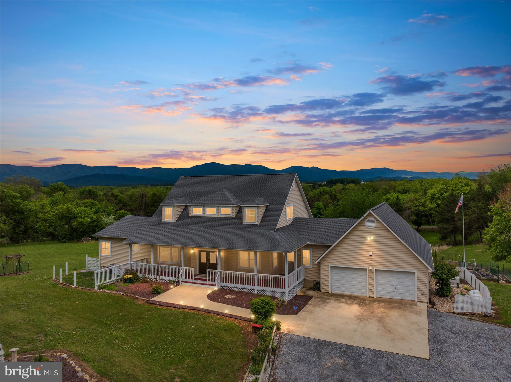 This one-of-a-kind, private, resort-style retreat in the heart of the infamous "Shenandoah Valley" offers the perfect blend of luxury, peace, and convenience. Sitting on 4.83 acres and offering over 4,000 square feet of living space, this exceptional property is surrounded by some of the area's most popular attractions including the Mimslyn Inn, Hawksbill Greenway, Caverns Country Club Resort, Luray Caverns, Yogi Bear's Jellystone Park, Mindrolling Lotus Garden, Lake Arrowhead, Kennedy Peak, and Skyline Drive, just to name a few. Conveniently located approximately 10 minutes from shopping, restaurants, and the hospital, and less than two hours from Washington, DC.

Tucked away on a quiet private road with breathtaking 360-degree mountain views, this meticulously maintained property is fully fenced with a gated entrance featuring solar lighting, offering unmatched privacy where the only sounds you’ll hear are those of nature. The beautifully landscaped grounds feature five landscaping islands, mature plantings, multiple fruit trees, a fenced raised-bed garden area, fenced dog run, target shooting area, barn/stable with upstairs loft and solar power, plus a new storage shed.

The home itself has undergone extensive renovations and upgrades throughout. A welcoming oversized covered front porch leads into a stunning open-concept interior filled with natural light, highlighted by walls of picture windows, skylights, and panoramic mountain views from nearly every room. Hardwood flooring runs throughout the home, while all bathrooms feature ceramic tile.

The spacious kitchen is designed for both entertaining and everyday living with gorgeous granite countertops, an island with additional cabinetry, peninsula bar seating, deep farmhouse sink with reverse osmosis filtration for healthy water, gas cooking, newer stainless steel appliances, and 42-inch cabinetry. The adjoining living room features a dramatic floor-to-ceiling stone gas fireplace as its centerpiece.

The main-level primary suite is a true retreat, entered through elegant French doors into a private sitting area and oversized bedroom with tray ceiling, walk-in closet with pocket door and safe, and a luxurious ensuite bath with double vanities and tiled walk-in shower. Additional French doors lead directly to the rear deck. The main level also offers a beautiful library with custom bookshelves, a full bath, additional exterior entrance, and an oversized laundry/pantry area complete with abundant cabinetry, storage, laundry sink, and extra refrigerator.

Upstairs, you’ll find two additional spacious bedrooms, each with their own private full bathroom and cozy reading nooks. Between the bedrooms is a large sitting/recreation area featuring additional built-in reading nooks, storage, and a closet with sink and room for a mini refrigerator — perfect for guests or multi-generational living.

Outdoor living is equally impressive with a large rear deck offering multiple access points from throughout the home, steps leading to an entertaining patio, and a screened-in porch with ceiling fans overlooking the incredible scenery.

Additional features include:
• Attached oversized 2-car garage with workshop area and mudroom featuring dog wash tub
• New roof installed in 2024
• Whole-house 26KW Generac generator for uninterrupted power and water
• New well pump and piping
• 80-gallon water heater
• Whole-house filtration system with water softener and UV light

Every detail of this extraordinary property has been thoughtfully designed, upgraded, and meticulously cared for, creating a truly rare opportunity to own a private mountain retreat in one of Virginia’s most scenic locations.