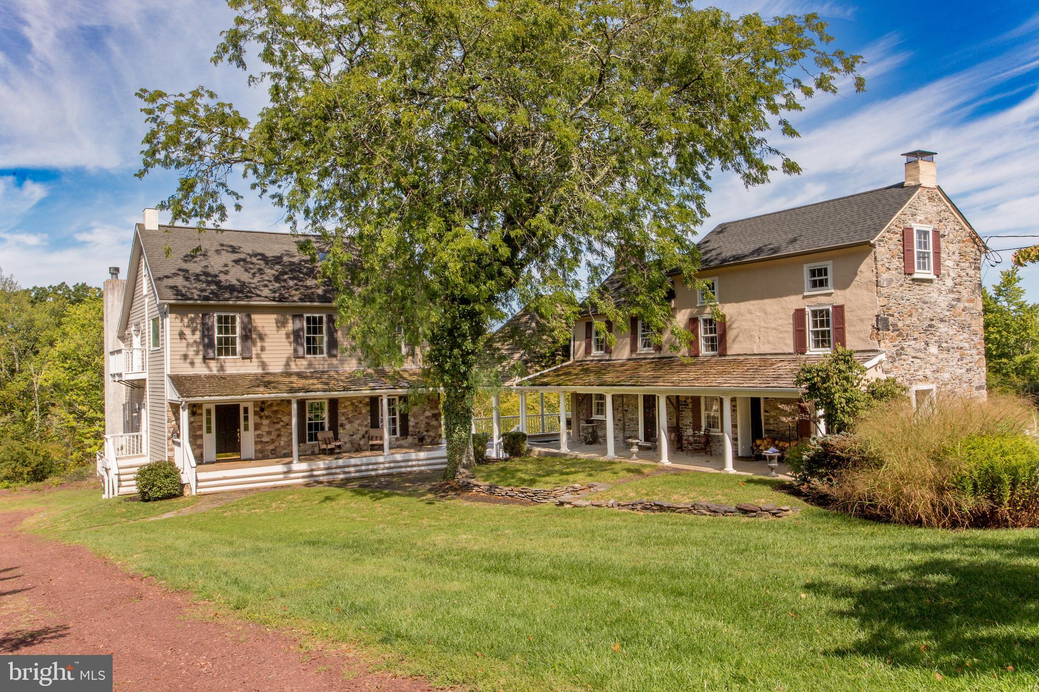 Seldom is there an opportunity to own an extraordinary property like this one. On one of the beautiful country roads in Solebury, Fox Hollow Farm has house with  adjoining  guest suites  on 37 acres of lawns, meadows, and partially wooded areas. If a serene retreat, absolute privacy and a relaxed and gracious lifestyle is what you seek, this is a property that will capture your imagination. The gated entrance opens to a long driveway that takes you to a home with two sections  built 200 years apart. Honoring the authenticity of the original 1806 farmhouse, the main residence is a reproduction designed to be similar in exterior appearance but with the finest modern features for luxury living. The two sections  share a large soaring height pavilion that has an expansive seating area and a sunken hot tub and connects the two porches. Enter into the newer section  with a 2-story foyer that sets the tone for the inspired design and the materials used. Pillars, detailed millwork, random width pine floors, many windows for natural light, bedrooms with private balconies are a few. The formal dining room is perfect for intimate or large gatherings, and the efficient and beautiful eat-in kitchen has custom cabinetry, two dishwashers and a 2-level island w/seating. A full width living room is warmed by a woodburning fireplace and an Atrium door opens to a wraparound deck that connects to the pavilion. Completing the main level is a full bathroom. Upstairs is a wide hall from which you access the primary bedroom and bathroom suite overlooking the living room. A second bedroom has a hall bathroom next to it, A hidden staircase goes to the third floor attic, which is an enormous room to use as a spacious office  or flex space with French doors to exterior balconies.  Plenty of closets there! A huge walkout basement with 9’ ceilings and a door to a patio could be finished if you need more space.  And then there is the original farmhouse section  dating back to 1806! Imagine if walls could speak. With almost 2000sf of space, separated  into  2 two story guest suites  each main level  room has a wood burning  fireplace main level has  two  room with a woodburning fireplace and  filled with period charm. Pumpkin pine floors throughout , deep sill windows, Dutch doors, with 2 staircases to the second level bedrooms and two tile baths , an office or sitting room, two bathrooms, and a back staircase to the third  floor. The outdoors is filled with ponds, garden beds, a bubbling water feature  under a bridge, statues, bluestone walkways, an original springhouse, dry stack stone walls, and so much more. Two garages have space for vehicles, equipment and storage.    Bring your vision and creativity, your love of old and new sections,  beautiful surroundings, and a serene place to retreat to and renew. It's quite a property to call home. A spectacular farm in an excellent location close to New Hope, Doylestown, and Newtown and their amenities and commuting routes. The seller will not entertain any offer that is subject to a subdivision approval. One parcel with 37.9 acres and two small adjoining parcels with1.09 acres  combined. Seller in process of testing to provide  septic location for additional dwelling
