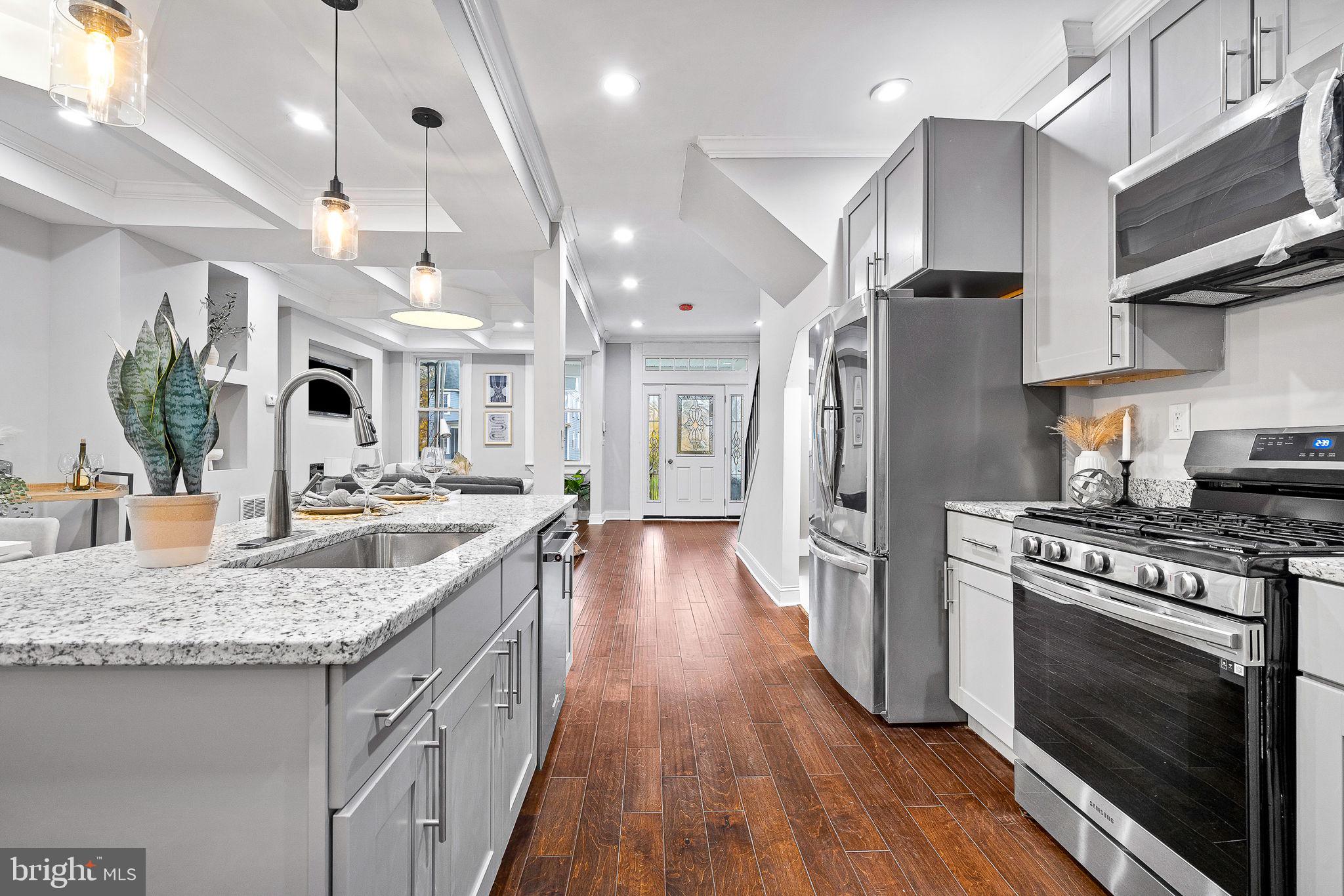 Huge price reduction on purchase price for the holiday! Come and visit this Beautiful, fully renovated townhouse in Baltimore City, featuring over 2000 sqft of living space. The main level features a custom ceilings, electric fireplace, new flooring throughout the house, recessed lights, a half bath and an open concept kitchen with new cabinets, granite countertops, backsplash and all new stainless-steel appliances! The upper level features a master suite and 2 additional bedrooms, and one hallway Full bath. This beautiful house has stylish finishing touches and modern fixtures. The basement is fully finished with a walkout exit and two additional bedrooms with a full bathroom. New HVAC system and ductwork, electricity and plumbing. Washer and dryer included. Nice backyard with 2 parking pad located in the rear of the house and a new deck. Don't miss the opportunity to make this stunning property your new home! Schedule you showing now!!