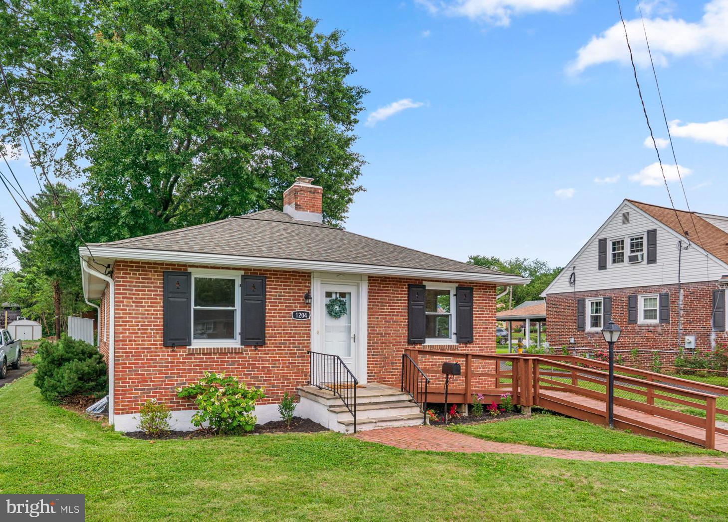 Tasteful renovations, quality finishes, and comfortable living spaces come together in this beautifully updated rancher in Catonsville’s Oak Crest neighborhood. Located at 1204 Edmondson Avenue, this three-bedroom, two-bath home offers thoughtfully redesigned spaces, refinished hardwood floors, and a long list of improvements that make it move-in ready.

The main level features a spacious living room centered around a unique corner-built wood-burning fireplace, creating a warm and inviting focal point. A nearby closet includes an existing gas connection, offering the next owner the opportunity to convert the fireplace to gas if desired. Hardwood floors run throughout the main level and have been professionally refinished, complementing the fresh paint and updated lighting found throughout the home. The living room flows seamlessly into the dining room, making the layout ideal for both everyday living and entertaining.

The renovated kitchen was completed with an eye for both style and function. White cabinetry, quartzite countertops, a glazed ceramic tile backsplash, stainless steel appliances, updated fixtures, and modern hardware create a clean and timeless look. The wide opening between the dining room and kitchen helps the space feel connected and open while still maintaining defined rooms.

Three nicely sized bedrooms with ample closet space are located on the main level, along with a beautifully updated full bathroom featuring a striking tile tub surround and quality finishes. Additional updates throughout the home include new two-panel interior doors, upgraded electrical fixtures and GFCI outlets where needed, plumbing improvements, and fresh paint on all interior surfaces.

The fully finished lower level expands the home’s living space and offers flexibility for a family room, game room, or whatever you desire. Recessed lighting and luxury vinyl plank flooring add both warmth and durability, while the second full bathroom features a classic white subway tile shower surround for a clean, polished look.

Outside, the backyard and large paver patio provide excellent outdoor living space for gardening, relaxing, or hosting gatherings with friends and family. The exterior has also been refreshed with landscaping improvements. Major systems include a Trane HVAC system installed in 2017, a 2024 water heater, newer windows, and a newer roof believed to be less than 10 years old. Conveniently located near shops, restaurants, schools, the public library, Baltimore-area attractions, and I-695, this updated home offers both quality and convenience in a sought-after Catonsville location. Verify school information on the Baltimore County Public Schools website.