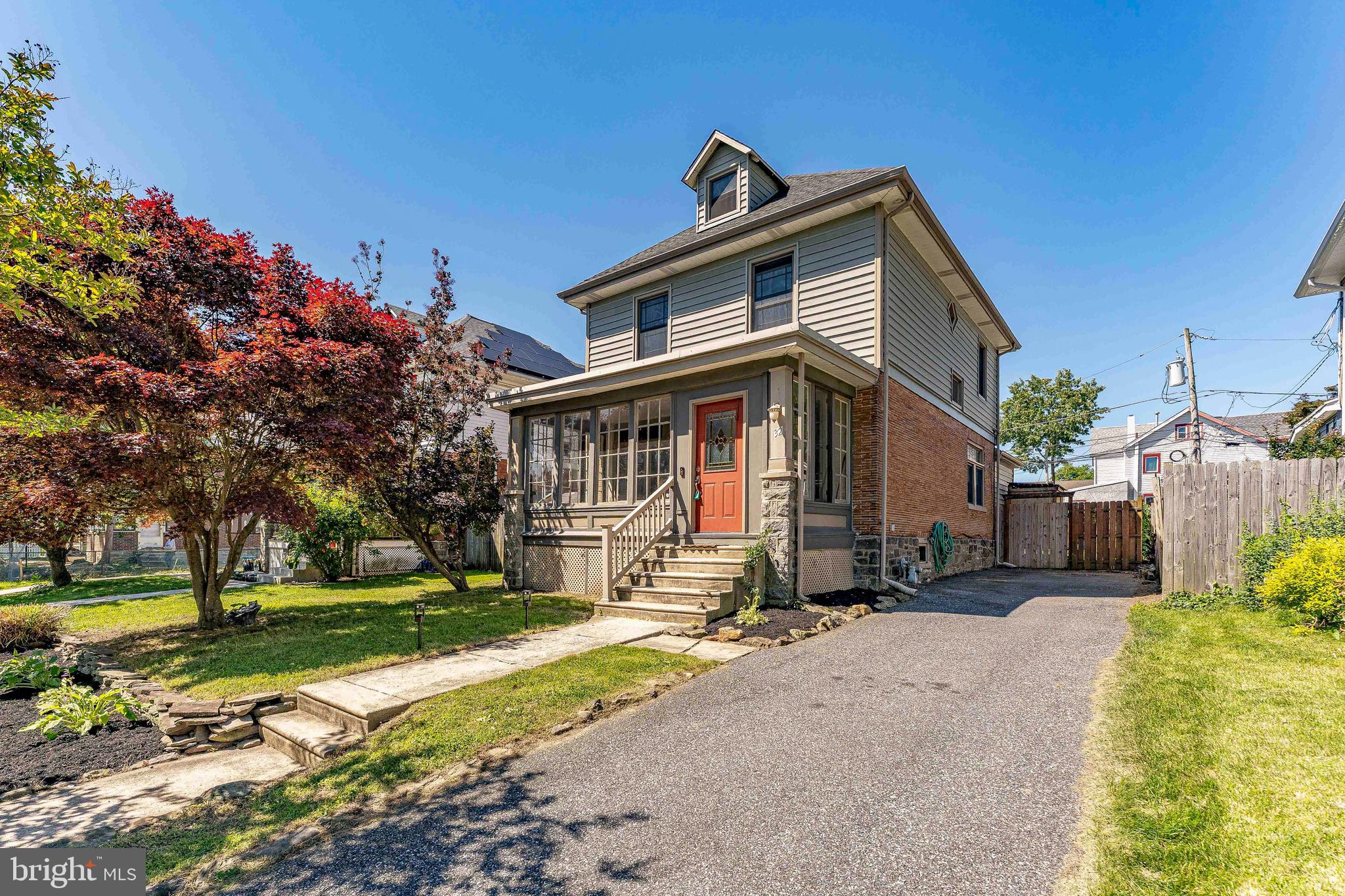 Welcome to 32 W Ridley Avenue, a charming 3-bedroom, 1.5-bathroom single family home in the heart of Norwood. Combining character, functional living space, and modern updates, this home also features a rare 4-car driveway and an ideal location close to everything you need. As you enter the home, you are welcomed by the enclosed front porch with luxury vinyl plank flooring, creating a bright and inviting additional living space. From there, step into the spacious living room featuring hardwood floors and multiple windows that bring in natural light from the porch area. The dining room continues the warm and inviting feel with hardwood flooring, crown molding, a ceiling fan with light, and side-facing windows that fill the space with sunlight. Just off the dining room is a conveniently located powder room. The kitchen offers a unique blend of style and functionality with hardwood floors, a partially vaulted wood ceiling with decorative molding, granite countertops, a peninsula with seating and a prep sink with disposal, stainless steel appliances, a pot filler, and front-load washer and dryer units for added convenience. Sliding glass doors lead directly to the composite deck, creating seamless indoor-outdoor living. The backyard is designed for both relaxing and entertaining, featuring a spacious composite deck, a level yard, a private outdoor shower, and a wooden privacy fence that creates a comfortable outdoor retreat. Upstairs, the primary bedroom includes hardwood floors, a ceiling fan with light, and a walk-in closet. The full hall bathroom features tile flooring, a tub/shower combination, and built-in wireless speakers for a modern touch. Two additional bedrooms, each with hardwood floors and ceiling fans with lights, are perfect for family, guests, or work-from-home needs. A staircase from the second-floor hallway leads to the third level, where you’ll find two spacious bonus rooms with carpet flooring and vaulted ceilings, offering flexible space for a home office, playroom, media room, or gym. The unfinished basement provides excellent storage space and includes a newer HVAC system and water heater. Not only does this home have everything you need, but it is also ideally located within walking distance of the Norwood SEPTA Regional Rail Station, providing convenient service to Center City Philadelphia and Wilmington. You'll also be just minutes from local shopping, restaurants, grocery stores, parks, Philadelphia International Airport, and I-95, making commuting and everyday errands a breeze. Don’t miss the opportunity to make 32 W Ridley Avenue your next home.