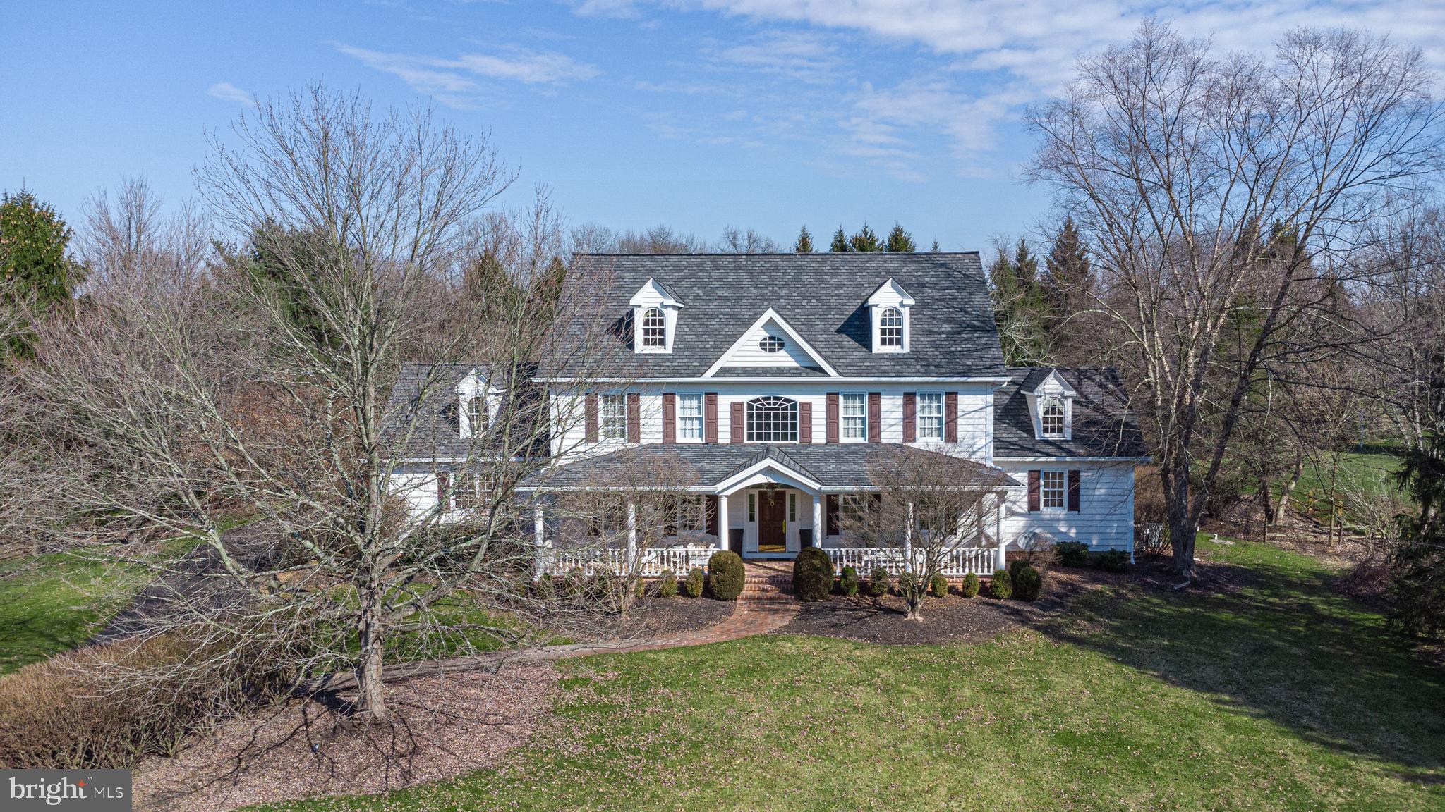 Situated in an exclusive enclave of only 7 custom homes with lush, mature landscaping is this elegant Ferman Lex masterpiece. As the largest home in the community, this refreshed and sophisticated estate offers beautiful architectural details and wonderful space for the discerning buyer. The stage is set with the expansive covered front porch with charming brick floor reminiscent of a southern veranda. A gracious, open plan highlighting a gorgeous, updated Charles Weiler Gourmet Kitchen with Wolf stove, custom hood, Bosch ovens and dishwasher, white cabinets and contrasting island, sleek Butler’s pantry and bright breakfast area with customized pantry and drink station leading into the 2 story Great Room with beautiful Palladian window. The spacious Main Floor Bedroom Suite includes doors out to the expansive brick and flagstone patios. The updated Main Bath features a freestanding tub, separate vanities with Quartz counters and huge walk-in closet with professional organizers. The upper level boasts 4 sizeable bedrooms, one en-suite, and over 1000 square feet of additional living space to include a kitchenette, living area and full bath with own private outdoor entrance allowing for wonderful flexibility. The Lower Level is finished to include a bar, billiards area, outfitted gym with 2 corner TVs, full bath and an exceptional 2 level theater room. Additional amenities include a large formal Dining Room, hardwood floors throughout, a newer roof, generator, solid wood doors, third floor attic perfect for storage, oversized 3 car garage, a private outdoor hot tub area and a firepit. The 1.5 acre lot offers privacy and versatility all within a quaint community setting in the award-winning and highly desired New Hope – Solebury school district.