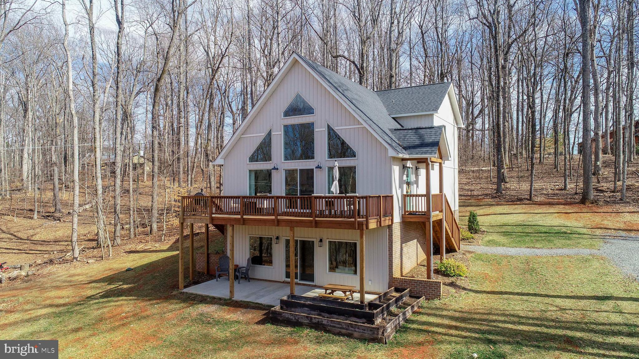 Just Listed! First Time on the Market – Custom-Built Home on 8+ Acres!  Nestled just outside the town of Orange, this stunning custom-built 4-bedroom, 2.5-bath home offers the perfect blend of modern comfort and peaceful countryside living. Situated on 8+ picturesque acres, the property boasts views of the land, a serene creek, and thoughtfully designed outdoor spaces. Step inside to an inviting open floor plan featuring vaulted two-story ceilings with exposed beams, creating a spacious and airy feel. The gourmet kitchen is a true centerpiece, complete with a huge island with seating, granite countertops, ceramic backsplash, and stainless steel appliances. Beautiful hardwood floors flow throughout the main level, enhancing the home’s warmth and charm. The main-level primary suite is a private retreat, showcasing board and batten walls, a walk-in closet, and a spa-like bathroom with a walk-in marble shower, double vanity with quartz countertops, and porcelain tile flooring. The laundry room is conveniently located on this level and offers ample storage and a prep/folding station. Upstairs, you'll find a cozy landing area/nook, three spacious bedrooms, and a full bath. The partially finished basement provides a large great room with a wood-burning stove, a walkout patio, and ample potential for additional living space, including a framed-in future bathroom. Outdoor enthusiasts will love the upper deck with stunning views, a raised deck by the creek, a garden area, an open storage shed and a water hydrant ensures easy yard maintenance. Enjoy the best of Orange County with local vineyards, breweries, historical sites, and more just minutes away. Plus, the home is conveniently located near schools, restaurants, the library, and shopping. Don’t miss this rare opportunity—schedule your visit today!