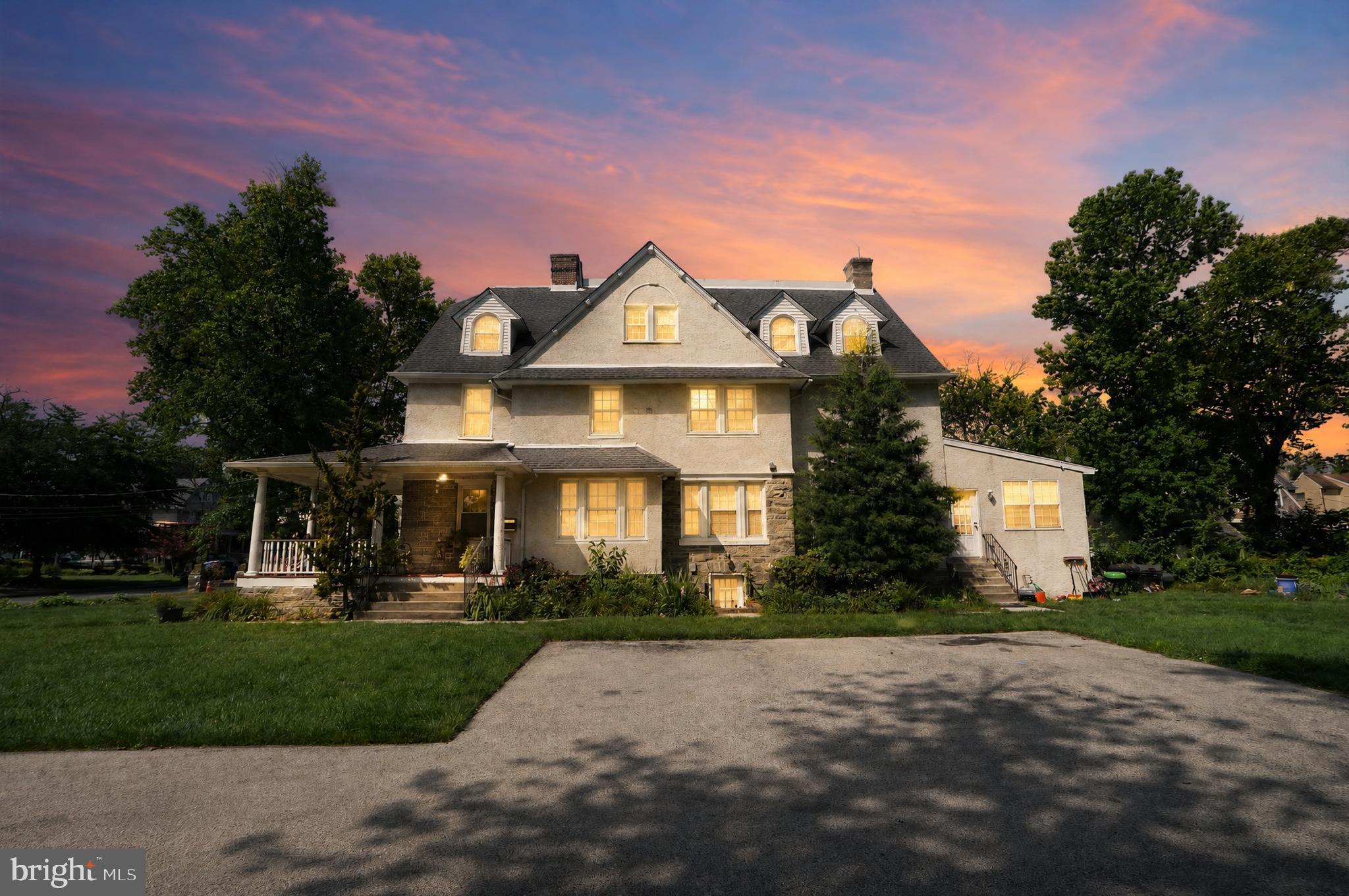 Rarely does a home of this scale and distinction become available. Situated on a quiet, wide residential street just minutes from the city, this magnificent Colonial twin flawlessly combines timeless early 20th-century craftsmanship with premium, top-to-bottom contemporary upgrades. Spanning three finished levels and just about 3,000 square feet of living space, every inch of this 5-bedroom, 3.5-bathroom residence has been thoughtfully improved with high-end fixtures. An inviting wrap-around porch leads inside to a sun-drenched main level featuring hardwood floors, designer lighting, a convenient guest powder room, and a functional entry area with a built-in storage bench. The expansive living room centers around a cozy fireplace, seamlessly transitioning into a formal dining room flanked by original built-in china cabinets, a bright den, and a true chef’s eat-in kitchen boasting 42-inch premium cabinets, elegant granite countertops, a central island, stainless steel appliances, and ceramic tile flooring. The second floor hosts a palatial primary suite serving as a private oasis, complete with a massive walk-in closet and a spa-like en-suite bathroom featuring a deep Jacuzzi whirlpool tub, a separate stall shower, and pristine tile work, alongside an additional generously sized bedroom and full bath. The third floor offers three more bedrooms and a full hallway bathroom, with effortless storage provided by dedicated linen closets and a rare, built-in cedar closet. Set on a massive double-lot footprint encompassing nearly half an acre, the backyard extends beautifully to the tree line, complemented by a private driveway that easily accommodates 8+ vehicles. Mechanically well maintained with dual-zoned central air, gas heating, upgraded electrical and plumbing systems, and a unfinished basement with a good ceiling height with exterior access, this home is walkable to the local park, public transportation, the library, local dining and shopping.
