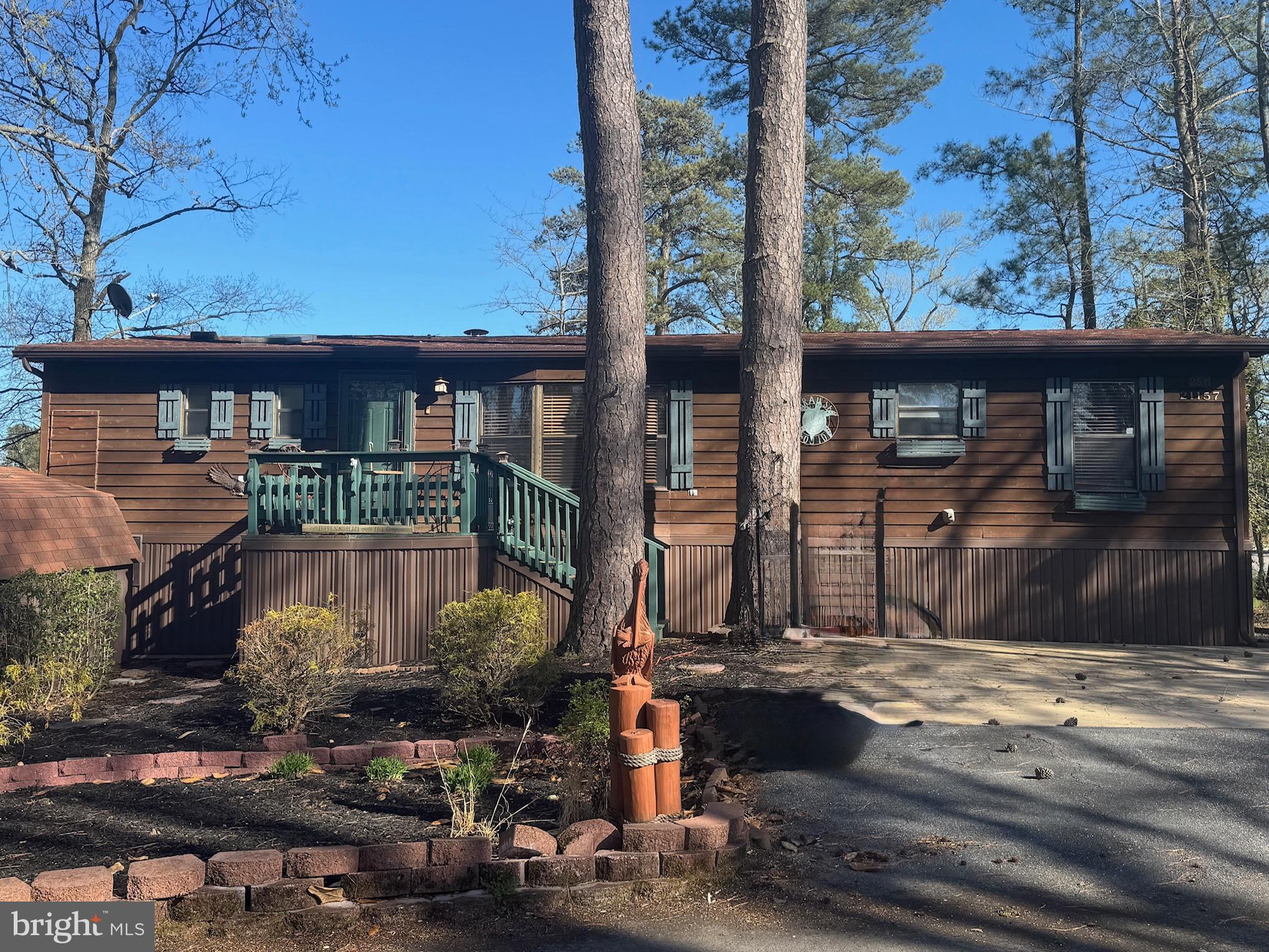 MOTIVATED Seller....bring an offer!  Welcome to your cabin at the beach:)  This home is located in the desirable water accessible Leased Land community of Rehoboth Bay. Tranquility awaits you with this home being positioned at the end of a cul-de-sac. The three seasons room is the perfect place to grab your Binoculars and bird watch over the wetlands. There are 3 good size bedrooms, 2 full baths, both with step in showers and 1 with a soaker tub,  updated kitchen with beautiful quartz countertop, pantry closet, newer appliances and easy maintenance vinyl flooring through most of the home.  HVAC/heat pump is approximately 2 years old, roof approximately 8 years old.  Monthly rent of $886.00 includes, water/ trash. Community amenities include, boat slips for rent, a community boat ramp, a boat storage area, a bayfront pool, a crabbing/fishing pier, a small sandy beach near the pool, tennis/pickleball courts and a whole lotta fun!  You are just a short drive  to the famous Rehoboth boardwalk, shopping outlets and a multitude of eateries.  Interested Buyer will have to make application with the community and pass a credit / background check.  Settlement costs will include 1/2 of a 3.75% DMV transfer fee, a settlement agent fee of appx $400 and any other expenses associated with this home will be pro-rated to the day.