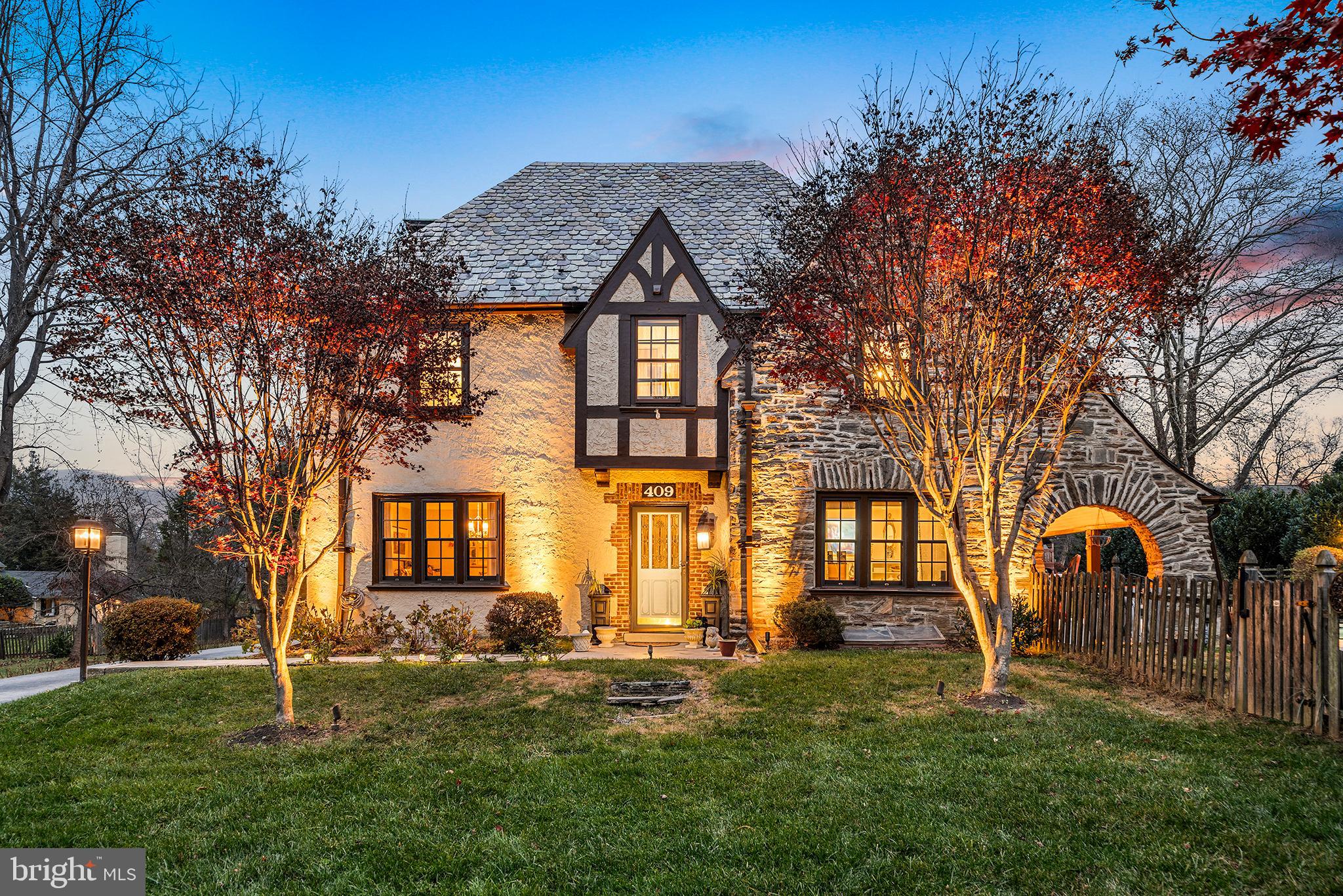 OFFER DEADLINE Friday 1/30. Welcome to 409 McClenaghan Mill Rd, a stunning Tudor that sits on a flat .71 acre lot in one of the most desirable neighborhoods in Wynnewood, within walking distance to downtown Narberth.

The first floor has a living room to the right with recessed lighting, built-in bookshelves, gas fireplace, Hunter Douglas window shades and a door leading to the covered pool patio. The formal dining room has two built-in cabinets and spacious room for hosting holiday dinners. The kitchen has granite countertops and stainless steel appliances including newer Miele dishwasher and an LG fridge. The coffee bar and pantry with custom cabinetry and quartz countertop were installed in 2024, and leads to the mudroom with custom cabinetry and bench, along with heated flagstone floors. Off the kitchen is a bonus room which could be used as a family room or office, along with a powder room.

The primary bedroom has recessed lighting and his and her closets. The second bedroom has an en-suite bath and could be used as a primary as well. The third bedroom connects to the current primary. The hall bath has a full bathtub and shower with granite tile, with Schumacher trellis wallpaper. On the third floor is the fourth bedroom, perfect for an in-law or au pair suite, which features a newly renovated full bathroom.

The basement was finished in 2020 and has a new laundry area installed 2024 with new Samsung washer and dryer and sink. The basement has storage shelving and egress to the outside.

The outside is perfect for relaxing or hosting parties with a heated pool by Sylvan Pools with elevated spa tub and waterfall, and new heater installed 2025. The covered pool patio offers great entertaining possibilities, and the fully fenced-in backyard is large and flat. The custom outdoor lighting elevate the home's curb appeal, and the three car garage has custom storage cabinetry and epoxy flooring. There is a long side yard to the left of the garage as well. Pella windows have been installed throughout the house in the last ten years as well.

This house is near Suburban Square, multiple train stations and bus routes, and is located in the award winning Lower Merion School District.