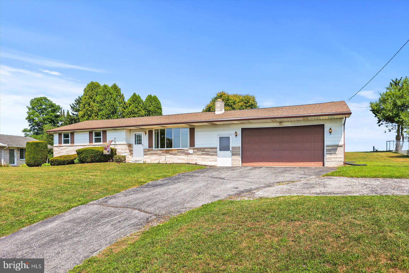 Welcome to 3591 Emig School Road, a well maintained Rancher in Dover school district with an oversized 2 car garage and breathtaking views of neighboring farmland! Inside you’ll find 3 bedrooms, 1 full bathroom, original hardwood floors, a spacious living room, and an eat-in kitchen with a separate dining area. Just off the dining space, a bright and inviting sunroom features vaulted ceilings and an abundance of windows, creating the perfect place to relax while overlooking the expansive backyard. Off the main living area are 3 good sized bedrooms, all with hardwood floors and the full bathroom with access from the hallway and primary bedroom.  The lower level offers a large rec room with paneled walls and a gas fireplace. With just a few finishing touches, this space has incredible potential to become the perfect family room, game room, or entertaining area. Finally when looking to relax outdoors, step outside and enjoy the peaceful backyard, where stunning panoramic views of the neighboring farm provide a picturesque setting for relaxing, gardening, or gathering with family and friends. Don't miss the opportunity to make this beautiful property your home. It truly is a must see to appreciate all it has to offer!