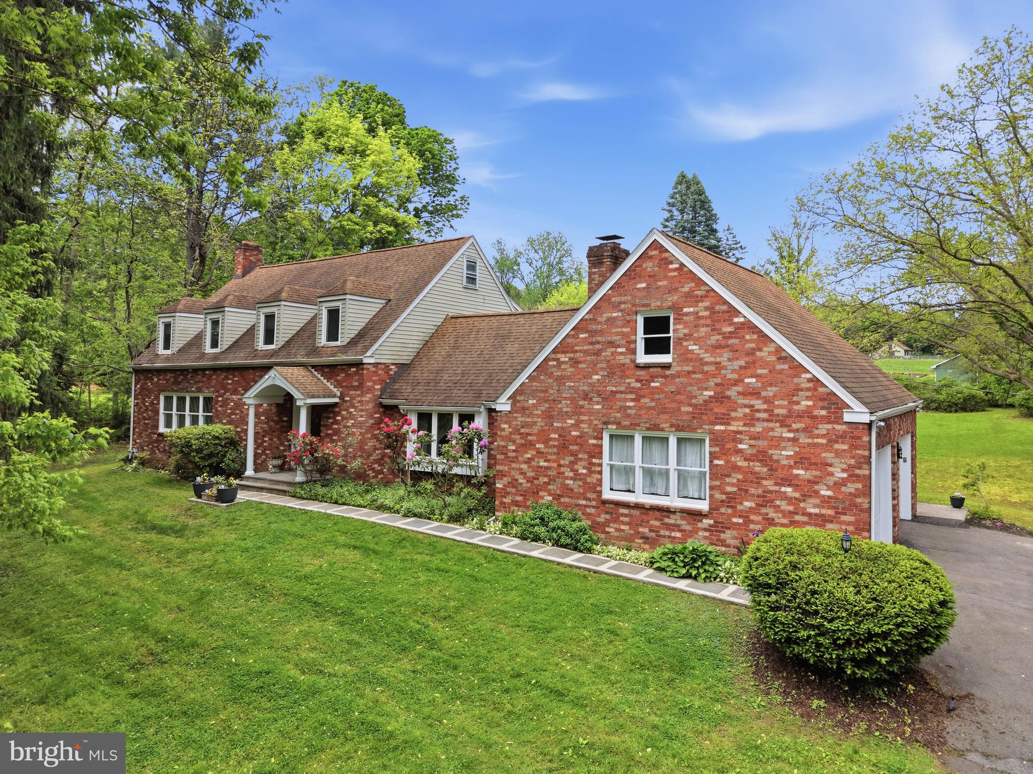 Welcome to 657 Millcross Rd in Lancaster, PA. Nestled near the Conestoga River and set back on a long private driveway, this wooded property offers a peaceful setting with added privacy. The home backs to wood-fenced horse fields, creating scenic, panoramic views throughout. This 4-bedroom, 3-bath home features well-maintained hardwood floors throughout and includes accessibility features such as a chair lift. The spacious family room showcases cathedral ceilings with exposed beams, a wood-burning brick fireplace, built-in shelving and cabinetry, a statement chandelier, and deep-set windows that bring in natural light, along with access to the attached two-car garage offering ample storage and a built-in workbench. At the rear of the home, a bright sitting room / office offers abundant natural light with a bay window, skylight, French doors, gas fireplace, ceiling fan, built-ins, and a built-in desk, along with a door leading to the backyard and access to a first-floor laundry closet with a built-in laundry board. The kitchen features ceramic tile flooring, stainless steel appliances, double ovens, a built-in desk, stained glass cabinetry accents, a dining area, and direct access to the backyard, while the formal dining room is accented with crown molding and a distinctive chandelier. An additional sitting room / sunroom includes carpeting, a second refrigerator, French doors, a sliding door to the backyard, and an exposed brick accent wall. The living room offers a second wood-burning brick fireplace, complemented by wall sconces that coordinate with the dining room chandelier, a built-in window bench seat, a large front-facing window for natural light, and crown molding. The foyer includes built-in decorative glass shelving, a coat closet, and a full bathroom with a stall shower. Upstairs, the second level features three bedrooms with wood floors, ceiling fans, and closet space, along with a shared full bathroom with ceramic flooring and a stall shower. The primary suite includes a vaulted ceiling, ceiling fan, and a connected dressing area with double closets, a built-in vanity, and cabinetry, while the en-suite bathroom features tile flooring, a stall shower, jetted tub, additional storage space, built-in shelving, and towel racks. Outdoor living is highlighted by an expansive deck overlooking the horse fields, along with a garden area and a strong sense of privacy throughout the property. The unfinished basement provides ample space for storage or a workshop, complete with a built-in workbench and shelving. This property is conveniently located near shops, dining, and entertainment, and is approximately 10 minutes from downtown Lancaster and the hospital. Schedule your private tour today!