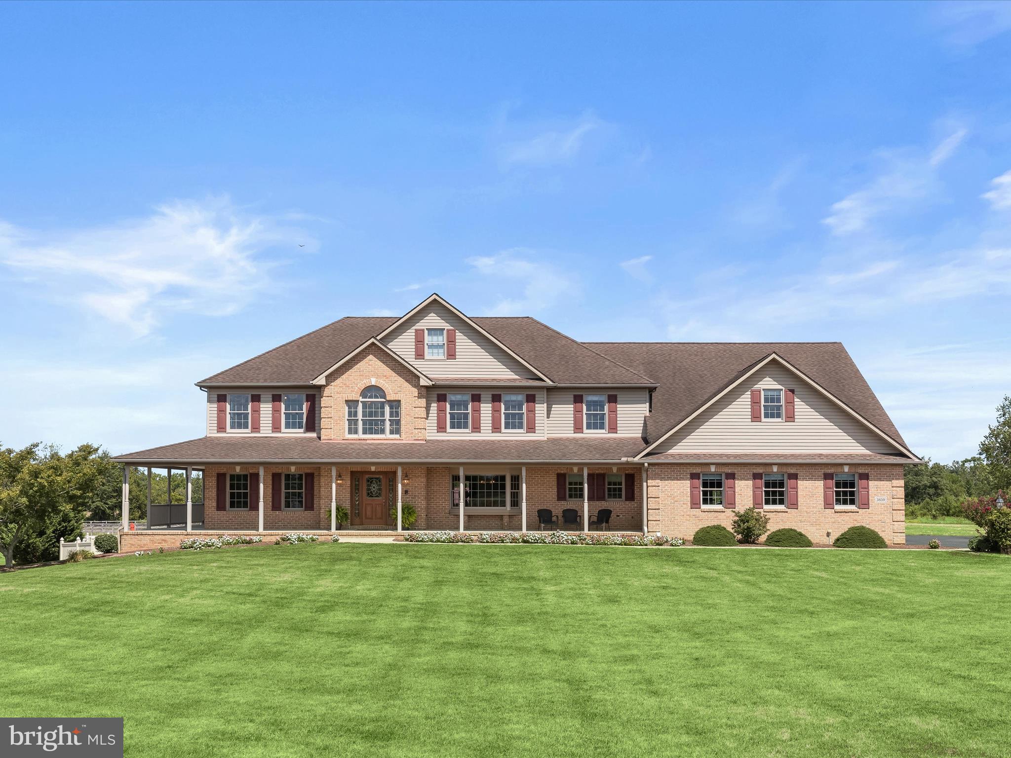 Set on 12 breathtaking acres of pristine landscaping and pasture, this exceptional estate blends refined living with equestrian amenities. The property features a three-car garage, a two-stall barn with automatic waterers installed and space for several more stalls easily, a lofted shed, and two pastures, one that can be divided into three separate paddocks. Three run-ins in the front pasture and two in the back provide ideal shelter for horses, goats, cows, or pigs, making this a true retreat for equestrians or homesteaders alike.  A sweeping front porch welcomes you into the main level, where gorgeous hardwood floors and a dramatic two-story foyer with a Palladian window and intricate glass accents bathe the home in natural light. The formal dining room exudes sophistication with a bay window, chair railing, and crown molding, while a private office with plush carpet offers the perfect work-from-home sanctuary. The spacious living room impresses with a gas fireplace, recessed lighting, and custom built-ins, and opens through French doors to a wraparound porch with serene views of rolling hills, perfect for seamless indoor-to-outdoor entertaining.  The gourmet kitchen is a chef’s delight, boasting Corian counters, dual islands including one with a breakfast bar, 42” cabinetry with display features, sleek appliances, and double ovens. A sun-filled breakfast area overlooks the grounds and provides access to the rear lanai, heated in-ground pool, and lounge area, creating the ultimate space for relaxation and entertaining.  The luxurious primary suite is a true retreat with a spacious bedroom, two walk-in closets with custom organizers (one connecting to a private bonus room), and a spa-like en-suite bath featuring dual vanities, a jetted soaking tub, a walk-in shower, and a walk-in linen closet. Four additional bedrooms, some with built-in bookcases, and a dual-entry hall bath complete the upper level.  The fully finished lower level expands the living space with luxury vinyl flooring, a game and exercise area, a bar with Corian counters, a wet bar with ice maker, a wine rack, and a gas stove.  The basement could also function as an in-law suite with a few modifications. With additional access to the pool area, built-ins, a full bath, and generous storage, this level is designed for both convenience and entertainment.  Perfectly situated near MD-140, MD-194, and I-795, this remarkable property offers a rare combination of luxury living, farm amenities, a three-car garage, and scenic tranquility. Shown by private appointment only.