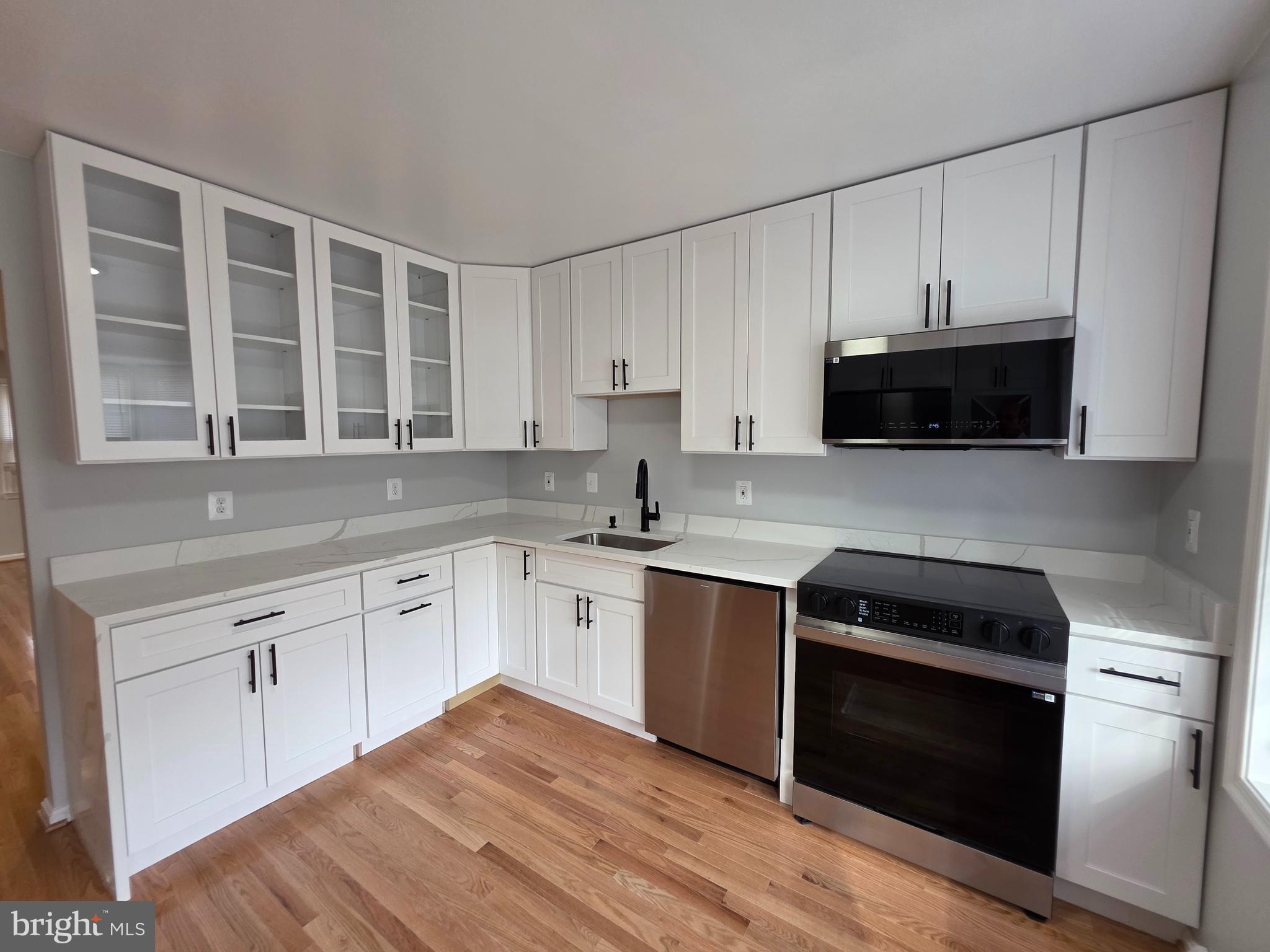 Completely renovated! Brand new kitchen-New kitchen cabinets, New Calcutta Quartz Counter-tops, New counter-tops, New Samsung Bespoke appliances: front door refrigerator, built-in microwave, quiet dishwasher,
slide in range and wine cooler. Main level has new Red Oak 3/4" hardwood floors. New carpet on upper level. New vinyl plank flooring in basement. New ceramic tile in master bath. Deck off main level. Patio on lower level. End unit with with very large side yard.