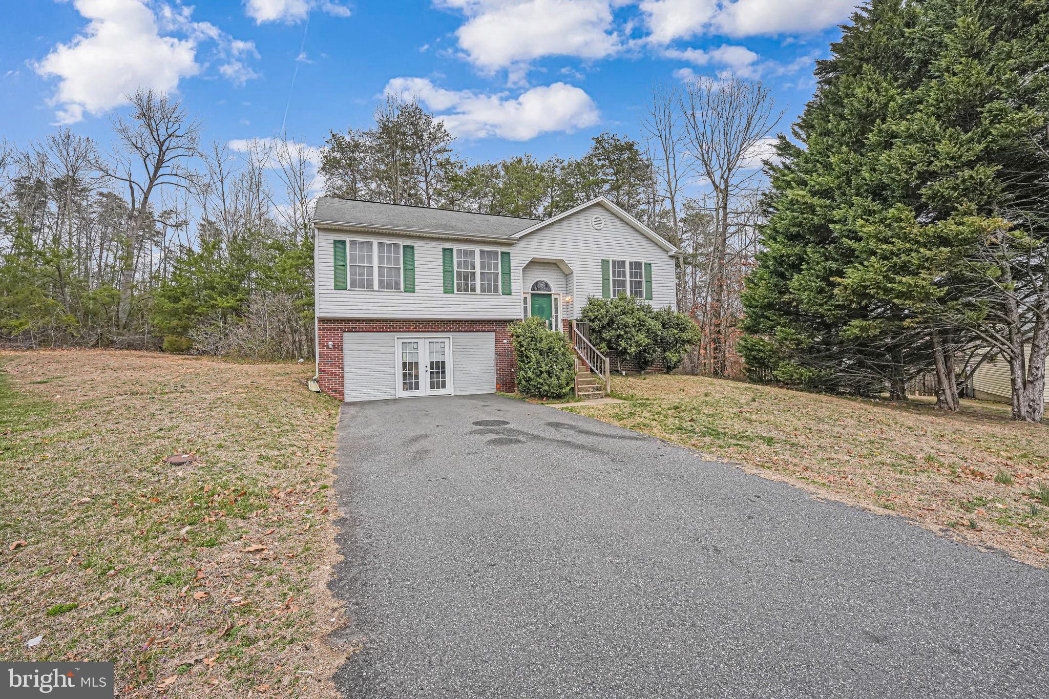 OFFER DEADLINE SET FOR 12pm MONDAY 3/24. Come see this tranquil 4 bedroom 3 bath home located on the end of a cul-de-sac.  Walk right into the split level with access to both the upper and lower level.  In the upper level you will find a spacious living room/dining room with easy access to the kitchen.  Down the hall you will find a bathroom as well as 3 bedrooms.  The primary bedroom is located on this level and has a good size closet as well as an en suite.  The downstairs features an additional bedroom and full bathroom.  The downstairs bathroom has a new vanity, new flooring and has been freshly painted.   From the downstairs level there is access to  the renovated garage.  This garage has been turned into a large living space that can be used for multiple purposes with an access door from the driveway.  There is still plenty of parking space in the driveway and cul-de-sac.  House is being sold as-is and sellers will not make any repairs to the property