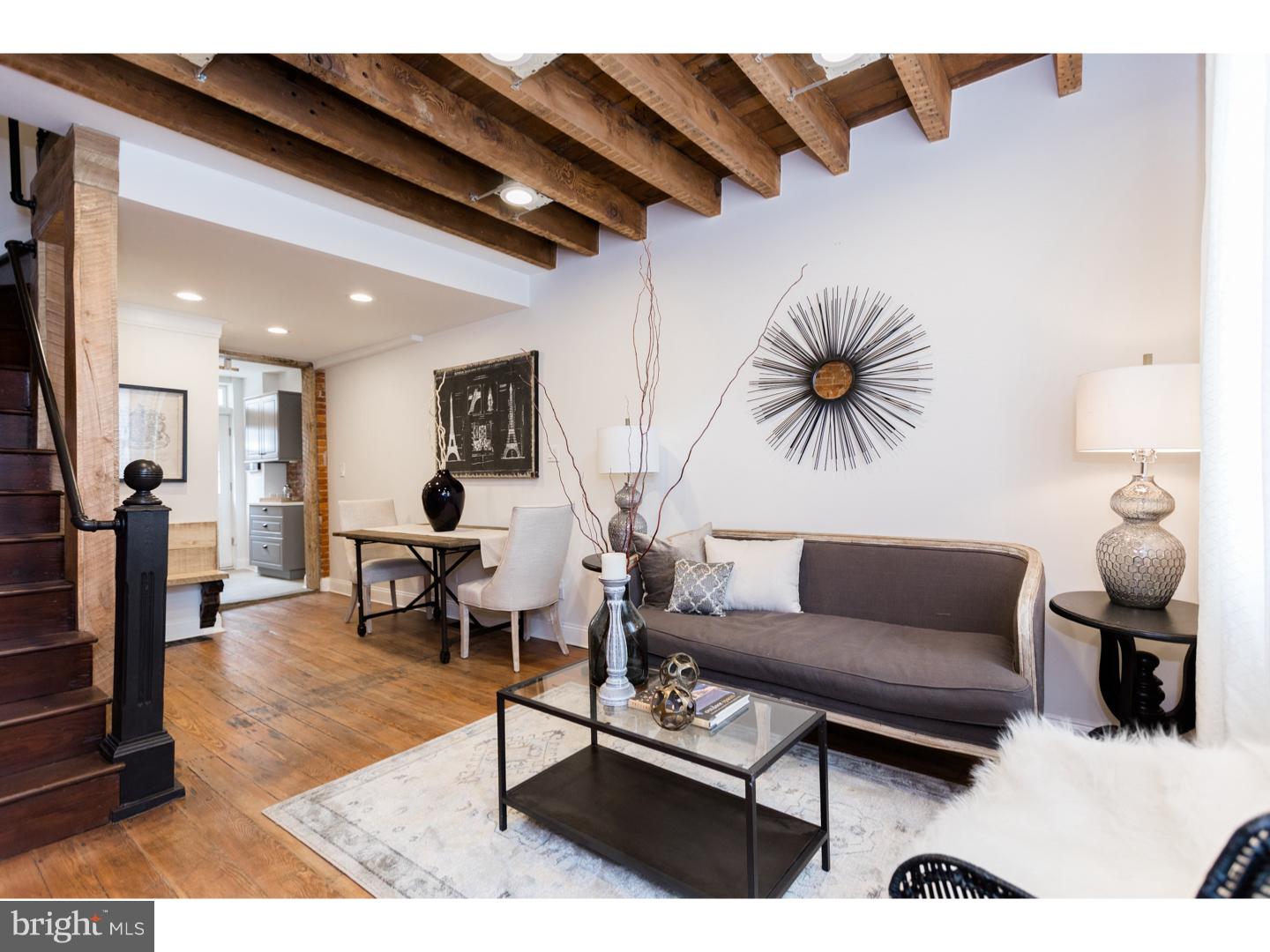 WOW. This COMPLETELY renovated 2 bed/ 2 bath will make you fall in LOVE. A 3 story, trinity-style MASTERPIECE astonishes w/ charm, style, and comfort! Some features include: rustic random plank hardwood floors, repurposed locally sourced materials throughout, exposed brick and beams throughout, barn doors throughout, a custom built bench in the dining room, a finished basement with built-in beverage nook with salvaged wood countertop, wine fridge, and storage. There is a custom kitchen with Quartz counters, a full stainless appliance package, 5 burner gas range, farmer sink with gooseneck faucet, poured concrete floors, and LED accent lighting. The home is fitted with recessed lighting throughout as well as a beautiful period schoolhouse chandelier in the hall and Victorian antique pendant chandeliers hang in the 3rd floor. The main bath has a repurposed sewing desk with vessel sink, wall mounted faucet and a beautiful glass panel shower enclosure and a convenient first-floor powder room. The rear yard is accessible from the kitchen with room for grilling, furnishings, and a small planting bed. This home has a NEST heating and cooling system. Located in South Kensington with easy parking just outside the home and on a friendly quiet block.  This is a HAVE-TO-SEE and a GAME- CHANGER!