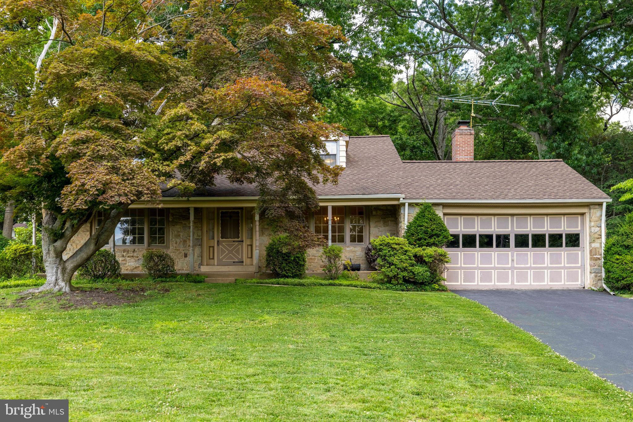This classic stone Cape Cod in Abington's sought-after Crosswicks neighborhood is ready for your personal touch! Offering the convenience of first-floor living, this four bedroom, two full bath home features a spacious layout and generously sized rooms throughout. An inviting front porch welcomes you into a bright foyer, where hardwood floors and abundant natural light create a warm first impression. A beautiful stone fireplace anchors the spacious living room, while the formal dining room, highlighted by a bay window, flows seamlessly into the expanded kitchen. The kitchen offers ample cabinetry and counter space, a center island, and a sun-filled breakfast room with skylights. An adjacent laundry area adds everyday convenience. The family room addition is a standout feature, complete with a brick fireplace, built-in shelving, double closets, skylights, and access to the rear patio—ideal for entertaining or relaxing. A versatile first-floor bedroom provides flexibility for guests, a home office, or a den, while a full tiled hall bath completes the main level. Upstairs, you’ll find three additional well-proportioned bedrooms, a walk-in hall closet, and a full tiled hall bath. The partially finished basement offers bonus living space, perfect for a recreation or media room, while the unfinished section provides room for storage and a workshop. An expansive attic adds even more storage capacity. The backyard and patio create the perfect setting for outdoor entertaining, gardening, or simply unwinding. An oversized two-car garage with built-in cabinetry adds even more value. An additional highlight is the new HVAC system. Ideally located near shopping, dining, Abington/Jefferson Hospital, schools, the library, and local parks, this home presents a wonderful opportunity to become part of one of Abington's most desirable neighborhoods. Don't miss your chance to make it your own!